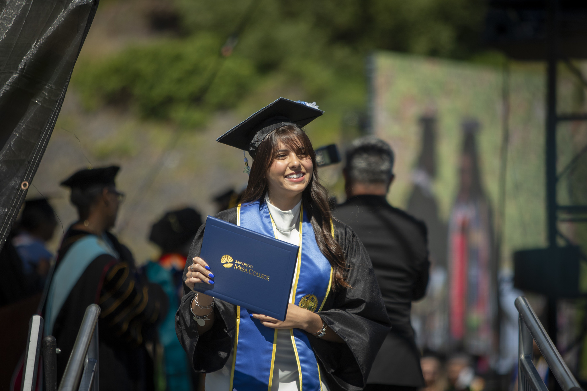 A student leaving the stage with their degree.&nbsp;