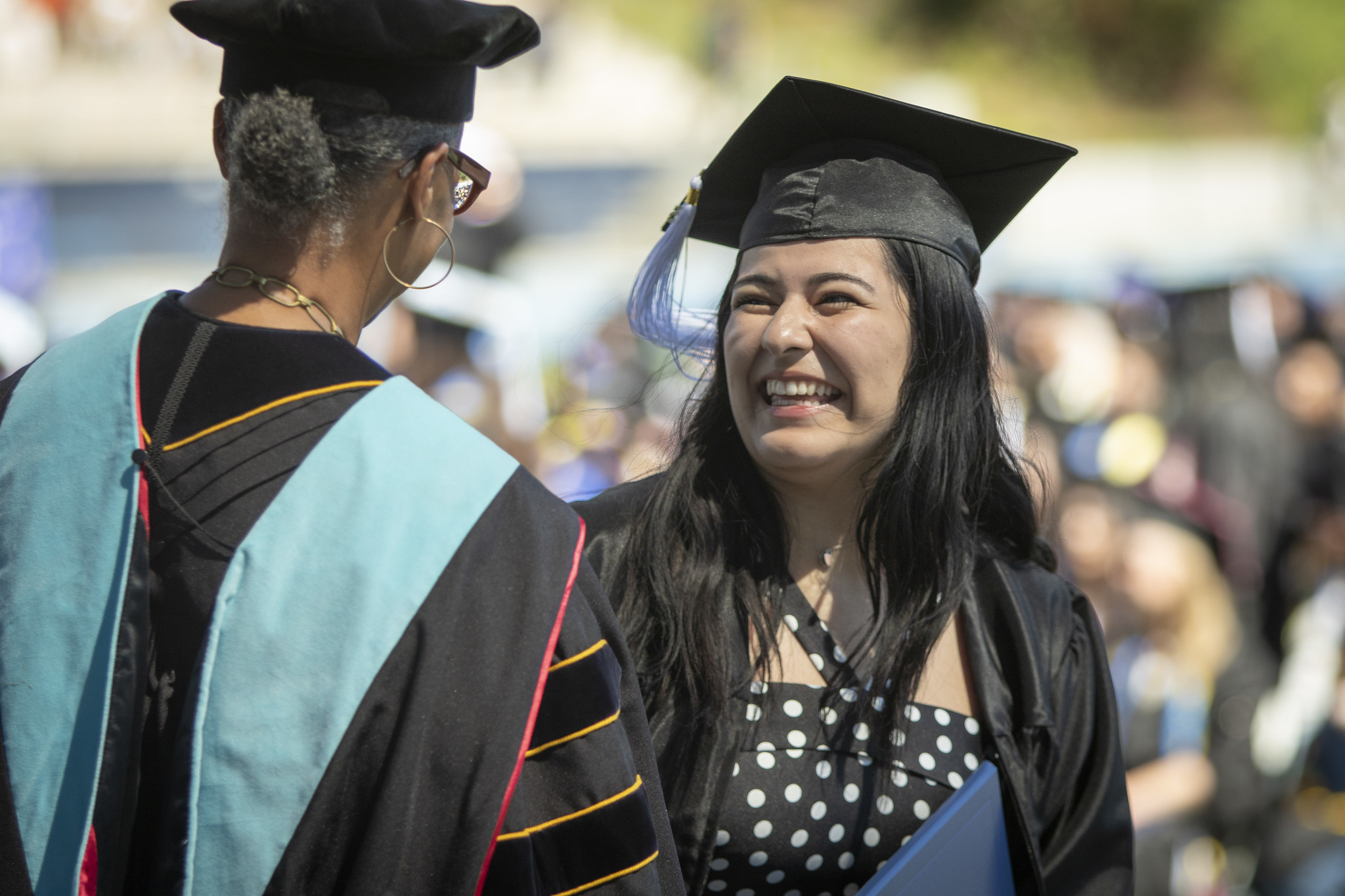 Mesa President Ashanti Hands shakes a graduates hand.&nbsp;