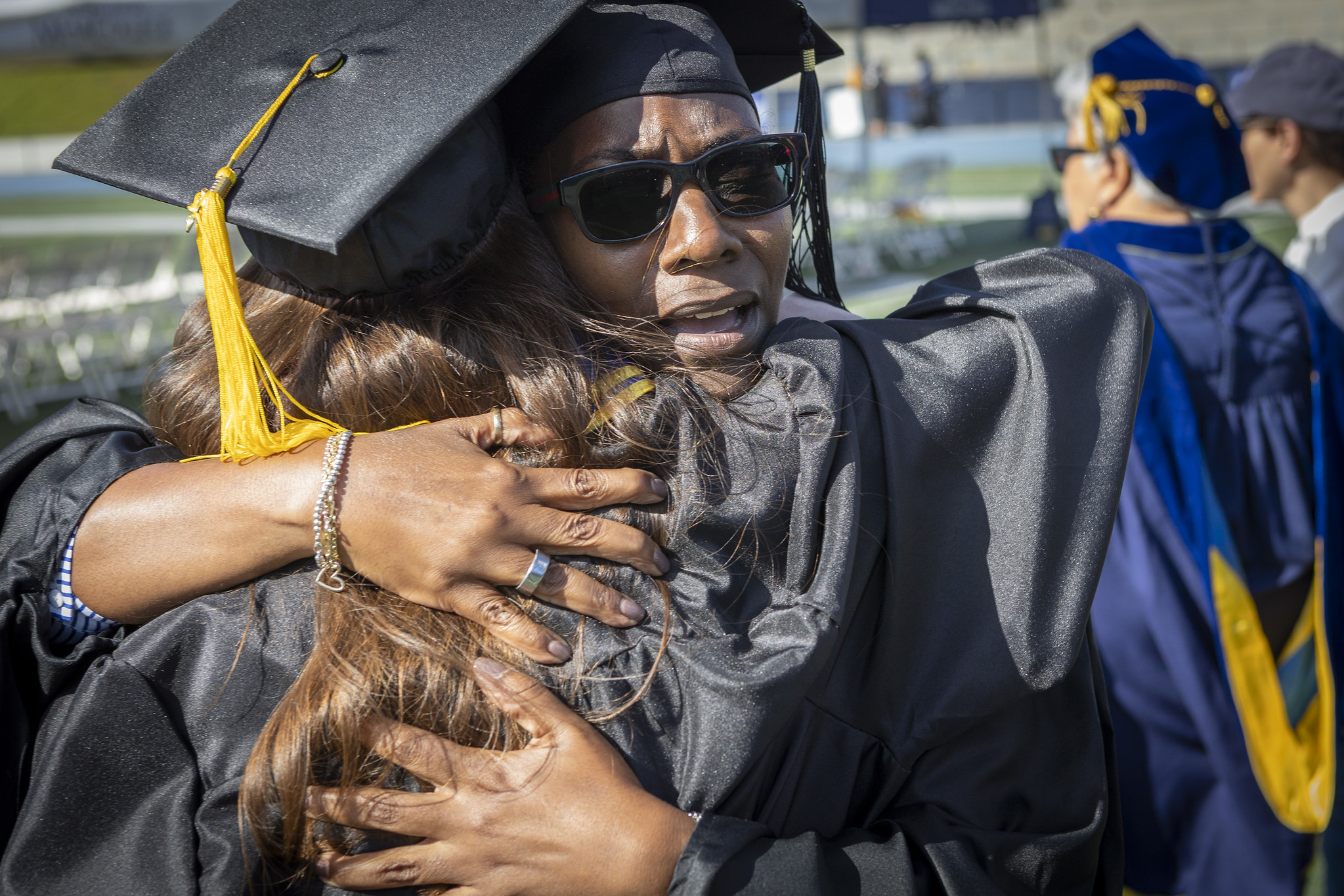 Two grads hug.&nbsp;