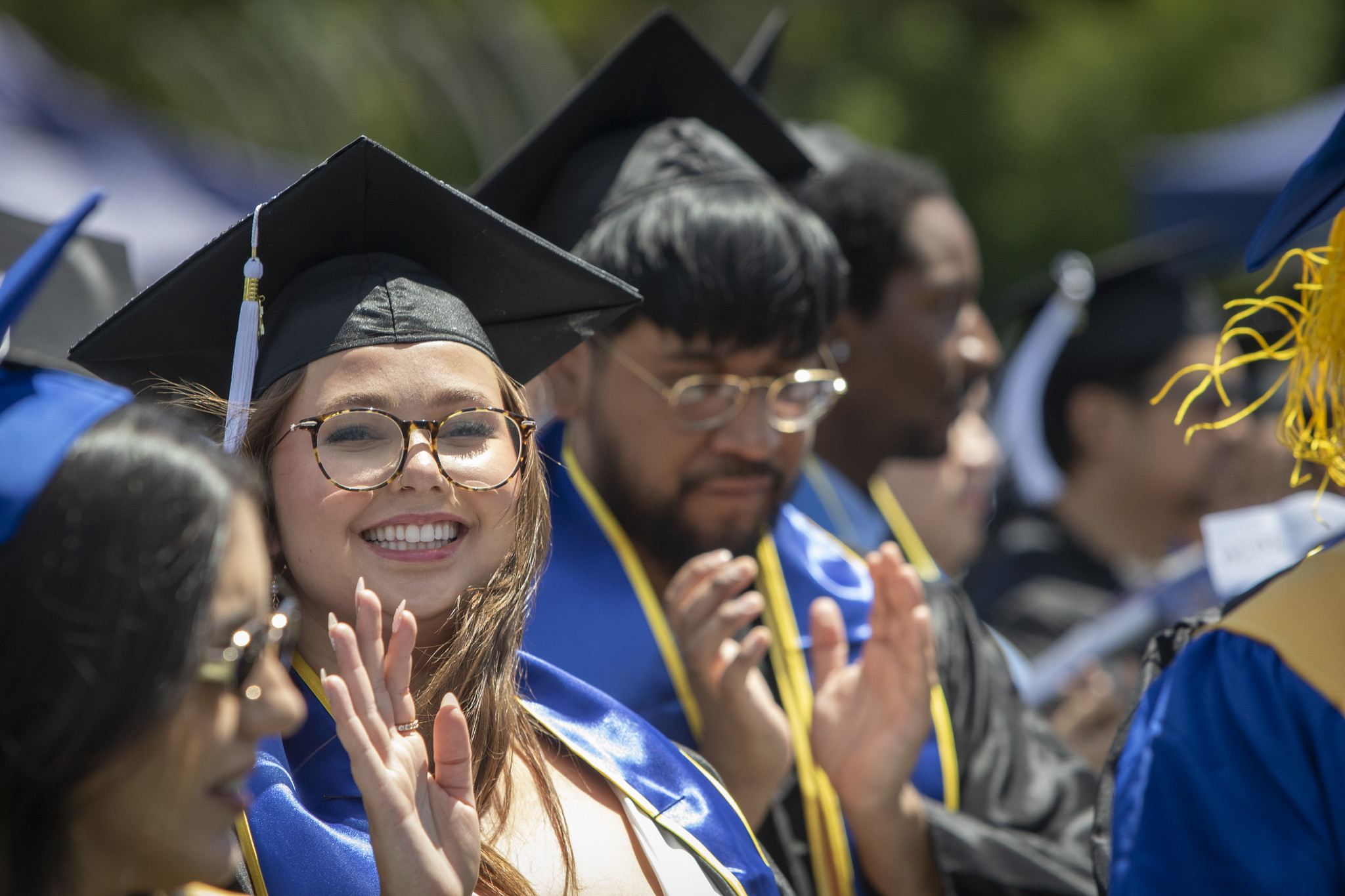 A grad in the audience waves.&nbsp;