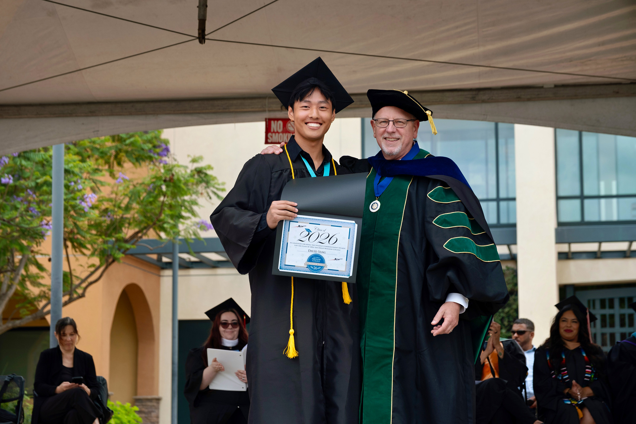 Miramar President Wes Lundburg gives the student Commencement Speaker an award.&nbsp;