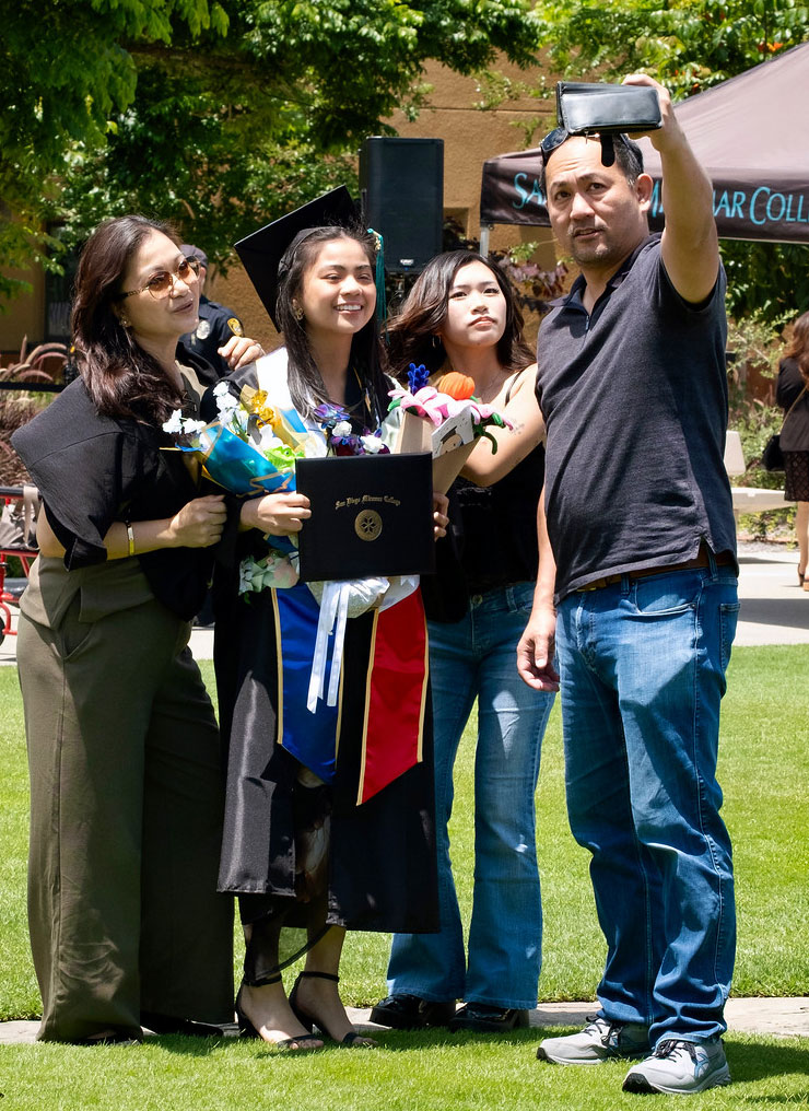 A family of four takes a group selfie.&nbsp;