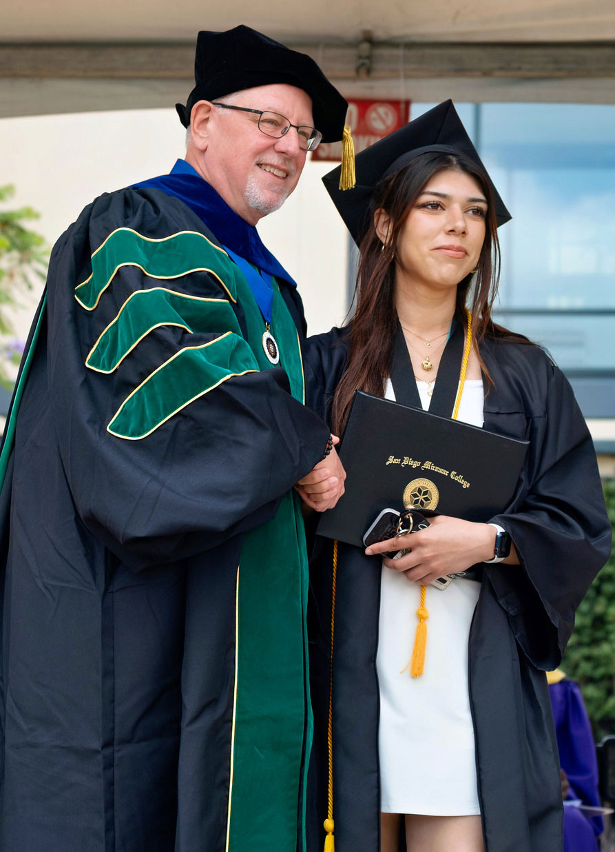 Miramar President Wes Lundburg hands a student her degree.&nbsp;