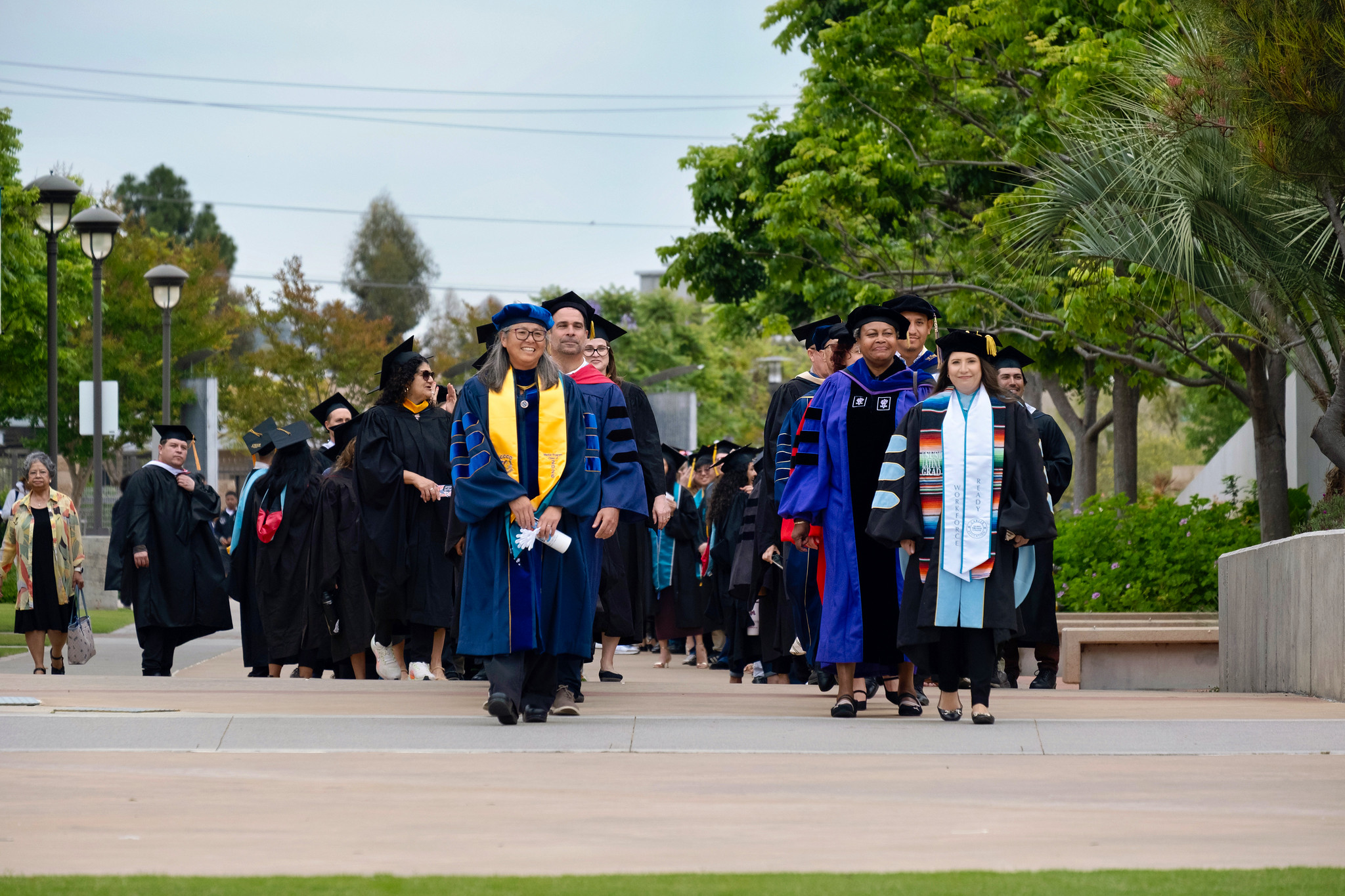 Faculty members in caps and gowns lead the graduates to their seats at the beginning of the ceremony.