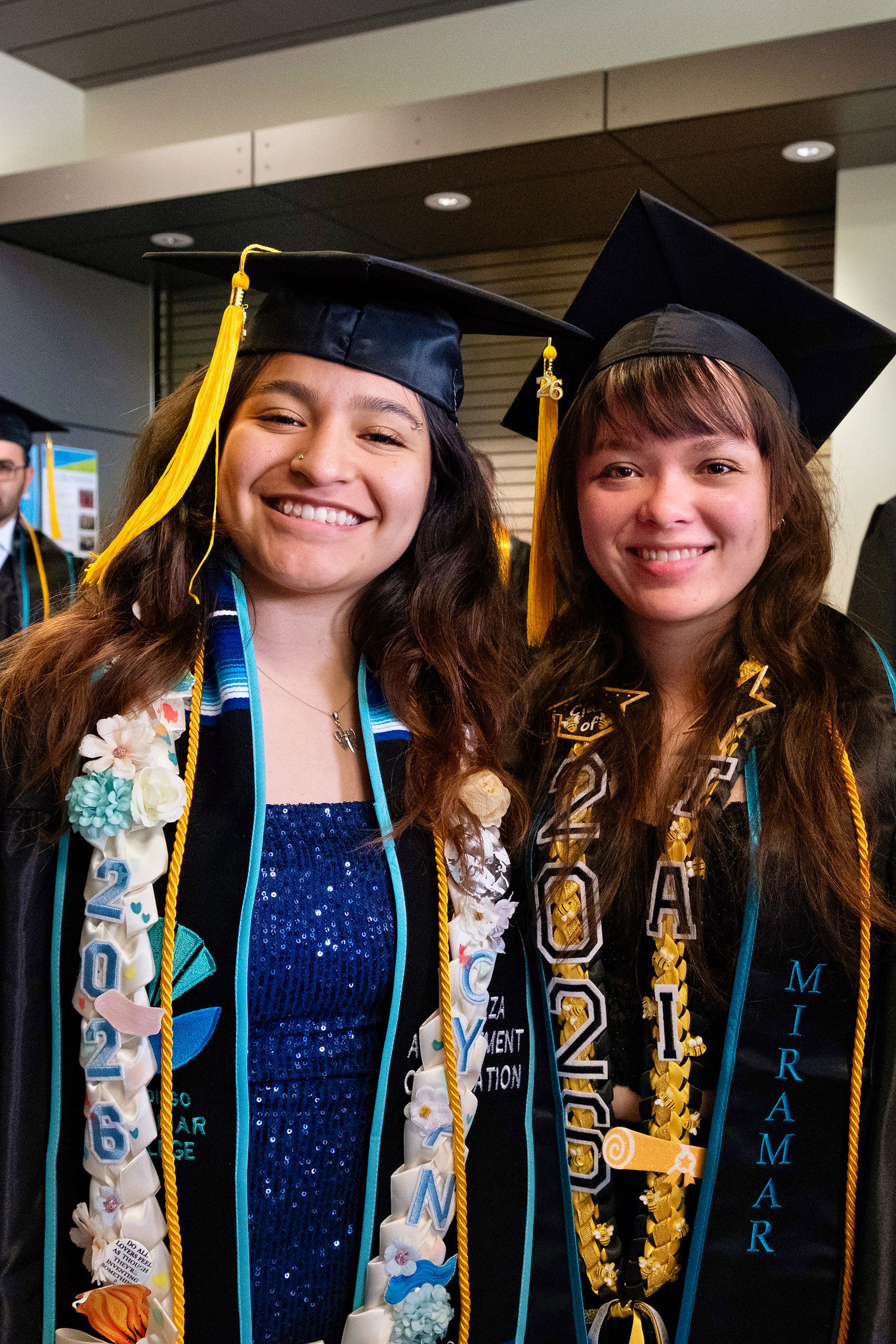 Two graduates are ready for the ceremony to start.&nbsp;