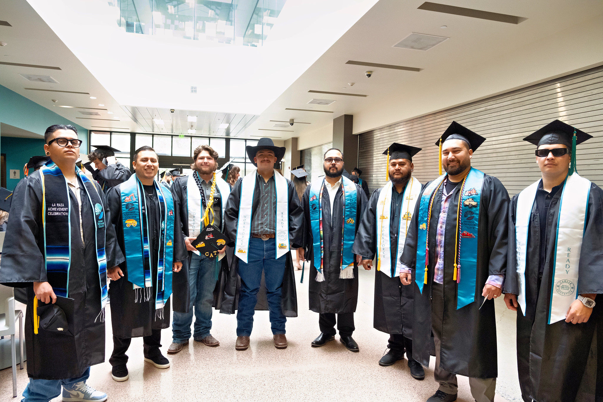 Eight graduates waiting for the ceremony to begin.&nbsp;