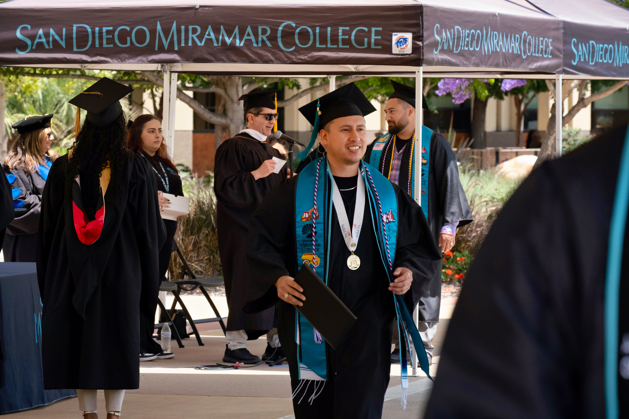 A graduate smiles after receiving his degree.