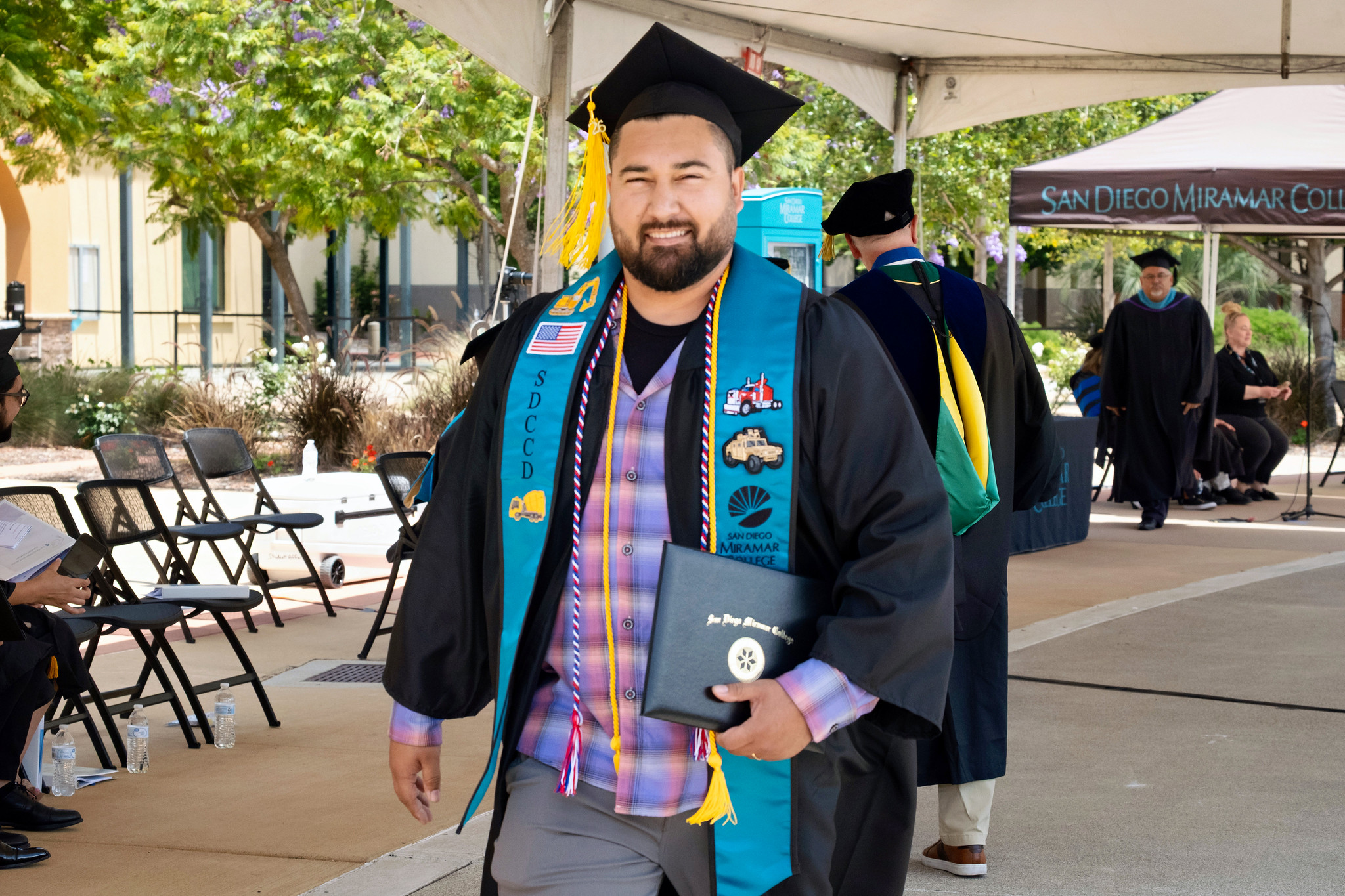 A graduate smiles after receiving his degree.