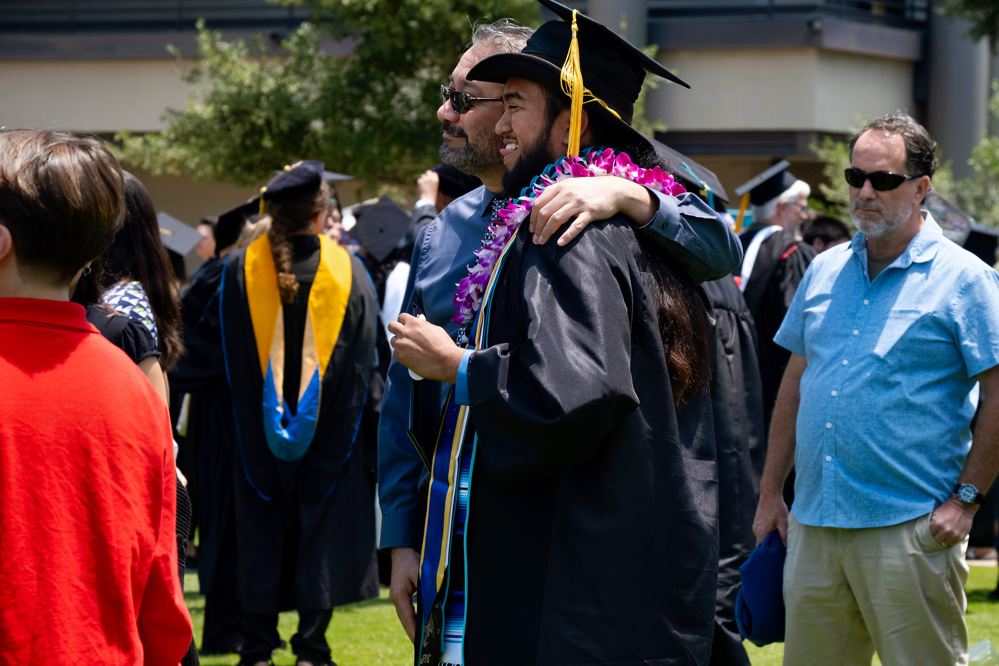 A graduate taking a photo with a family member.