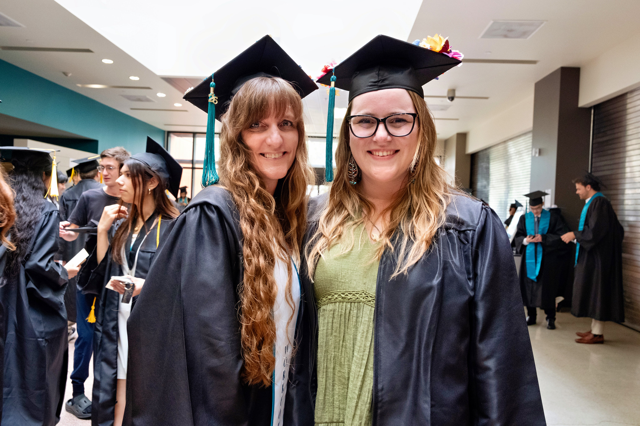 Two graduates waiting for the ceremony to begin.&nbsp;