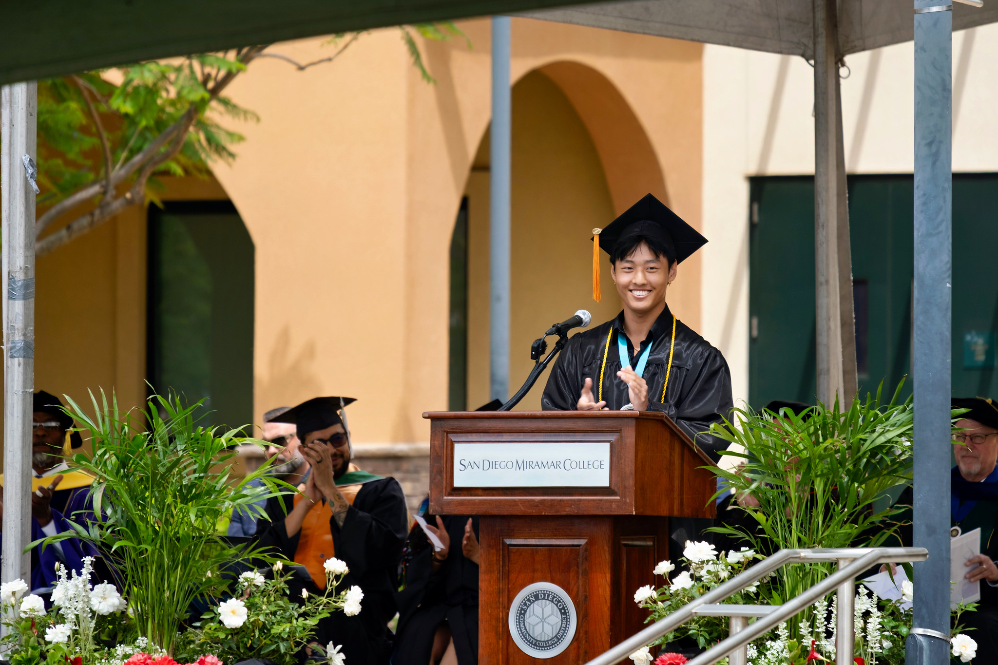 The student commencement speaker at the podium.