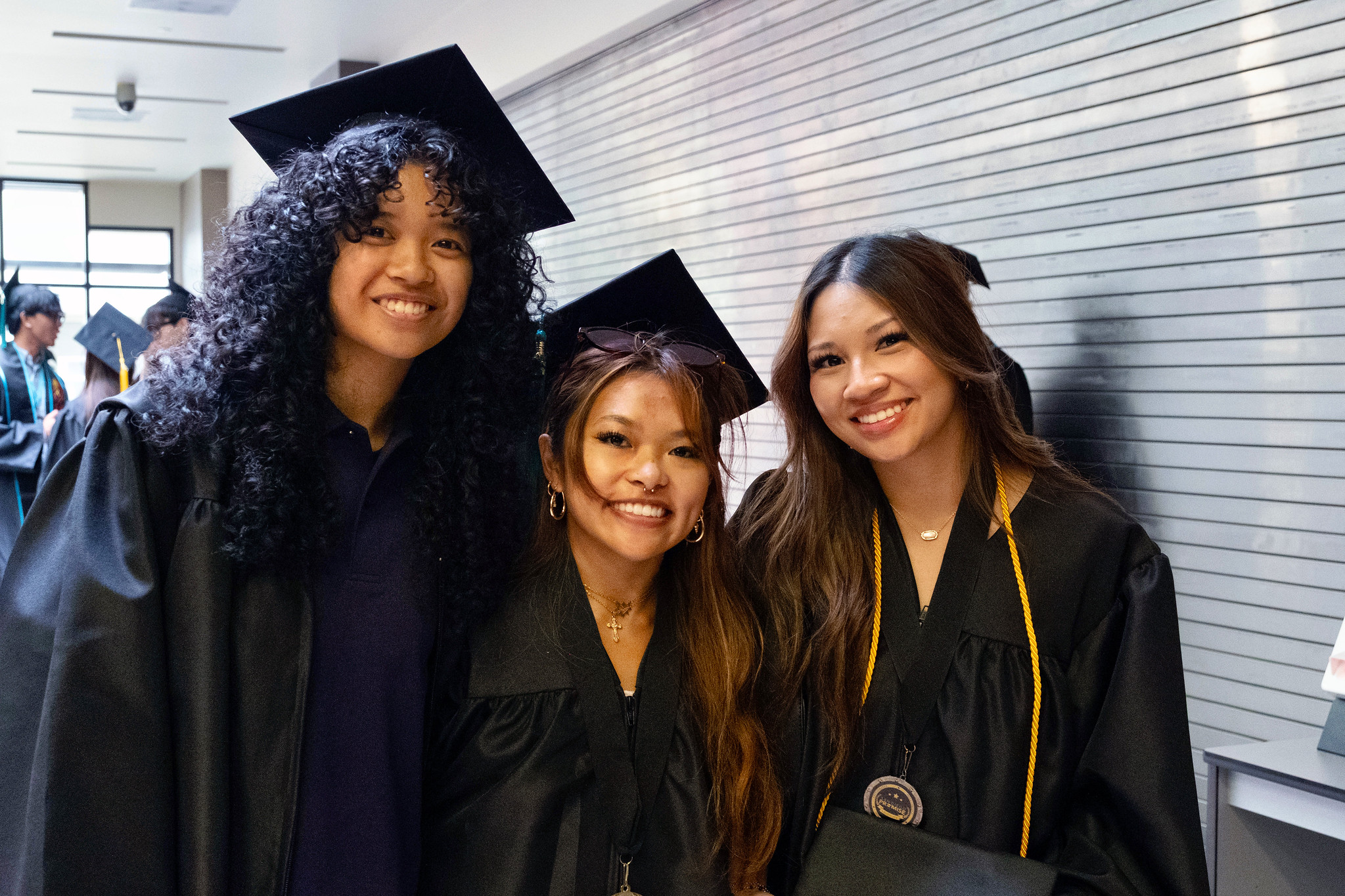 Three grads waiting for the ceremony to begin.