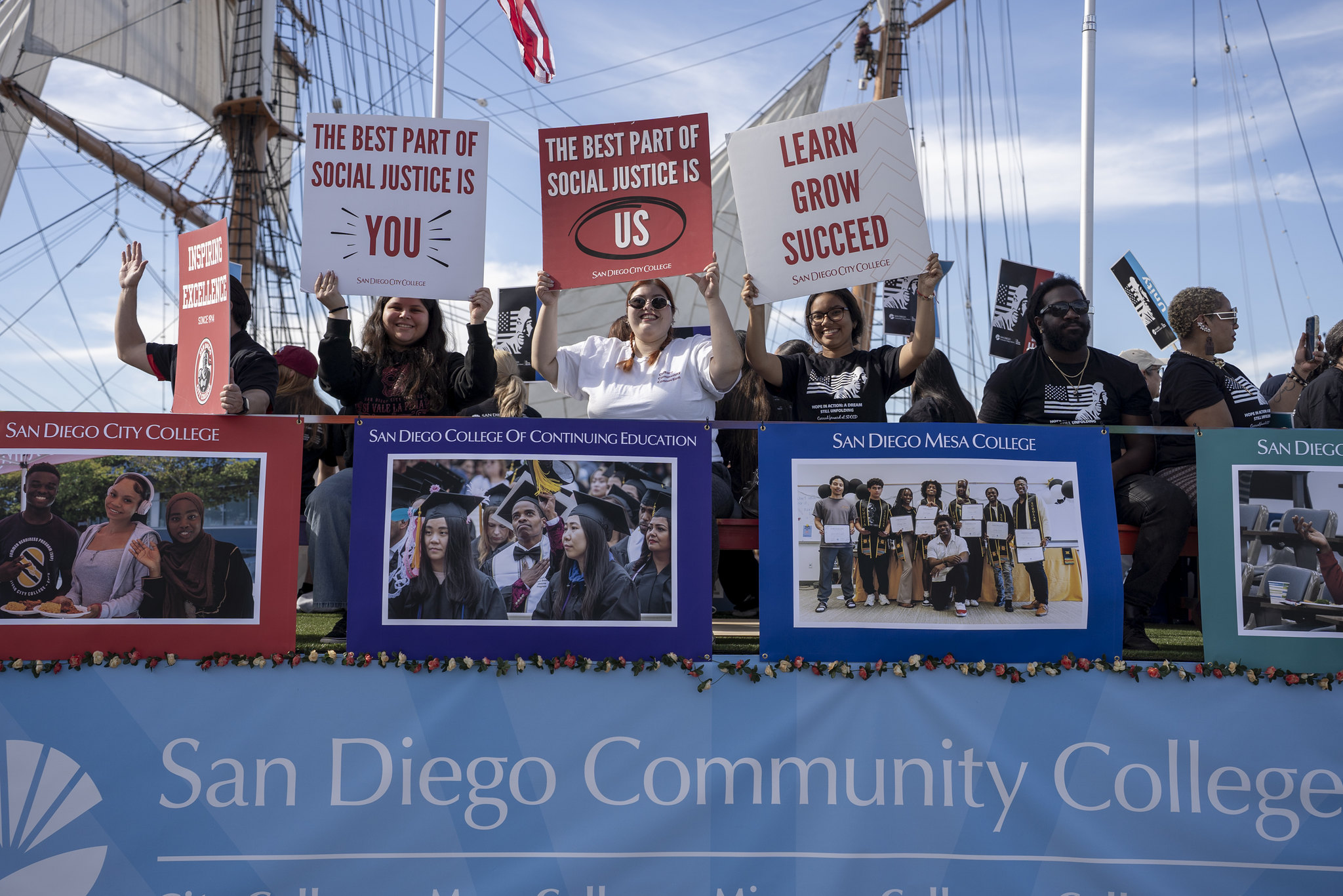 Three people on the float holding signs supporting social justice.
