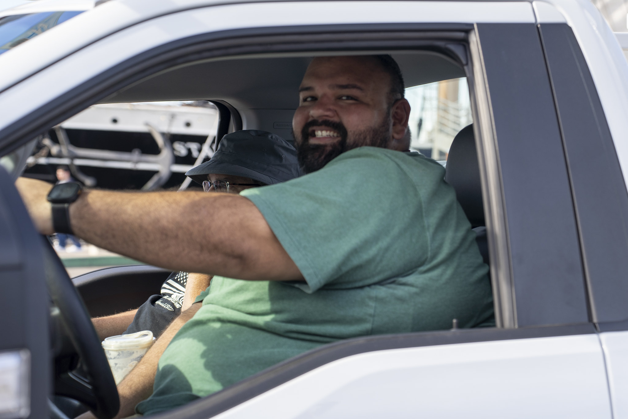 A facilities services crew member driving a truck in the parade.