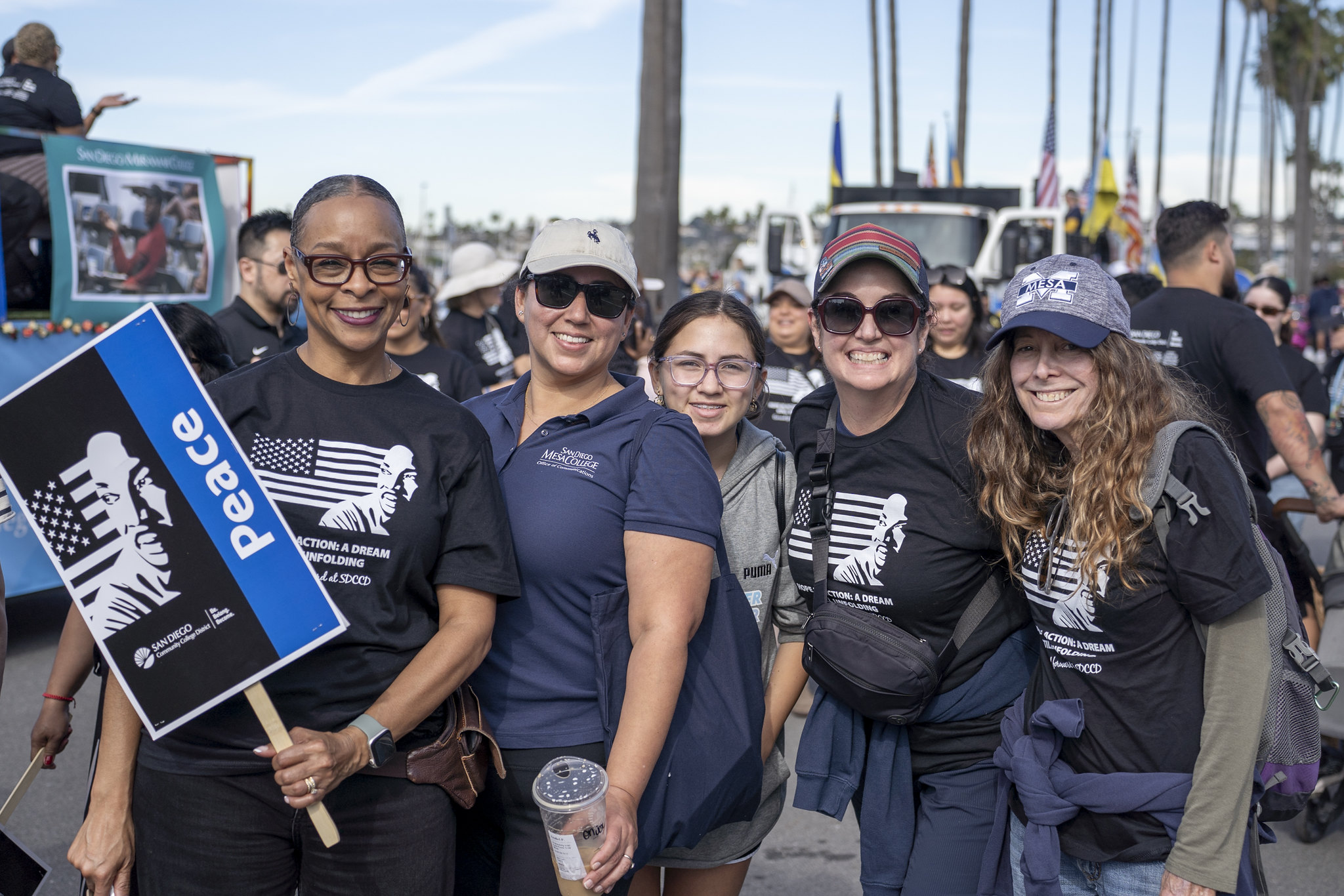Five parade-goers, including Mesa College President Ashanti Hands (left), take a group photo.