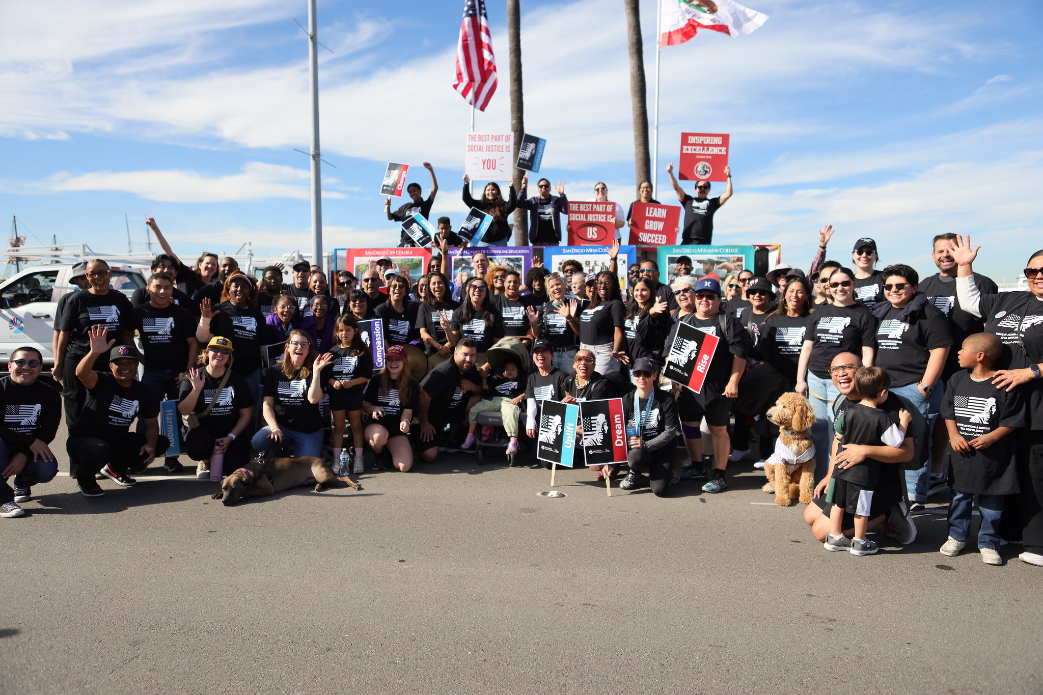 About 50 district staff and students take a group photo in front of the district's parade float.