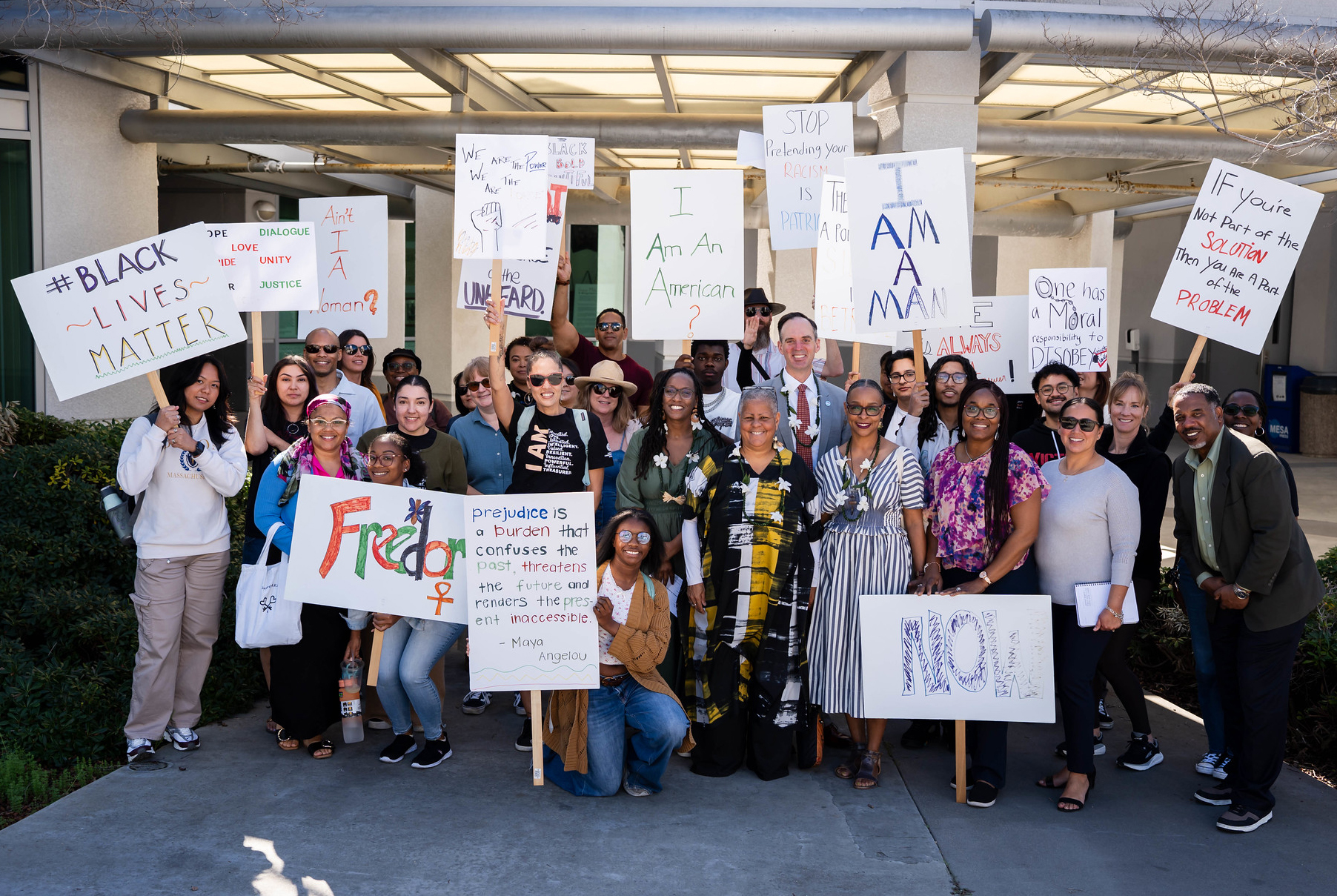 
A group of people holding signs supporting civil rights.
