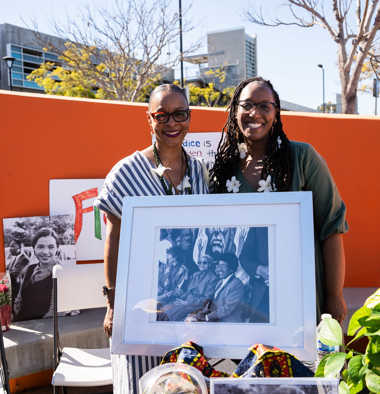 
Two ladies stand by a portrait of Rosa Parks and former Mesa College President Constant M. Carroll in the 1990s.
