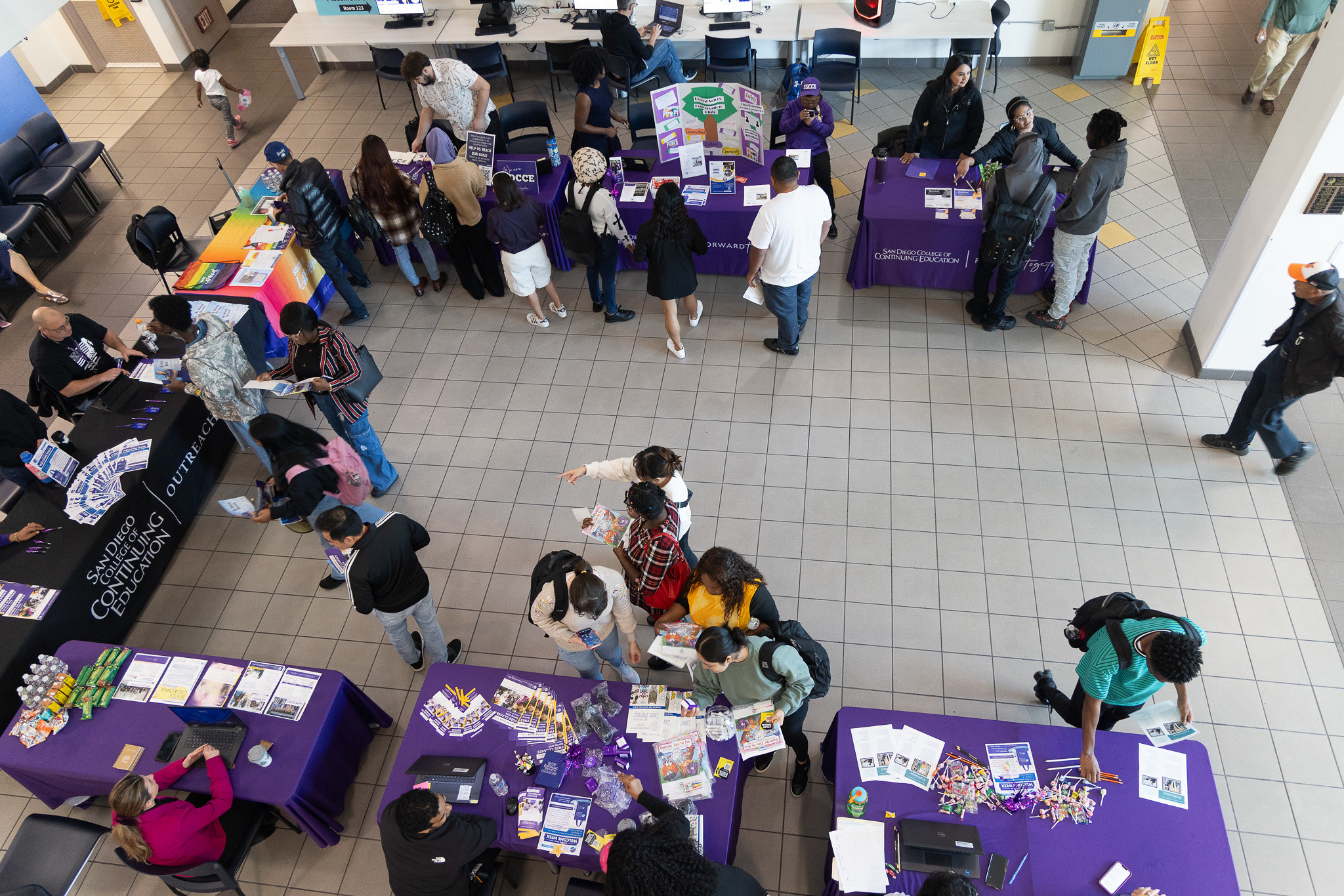 
A view from the second story looking at welcome tables on the first floor.
