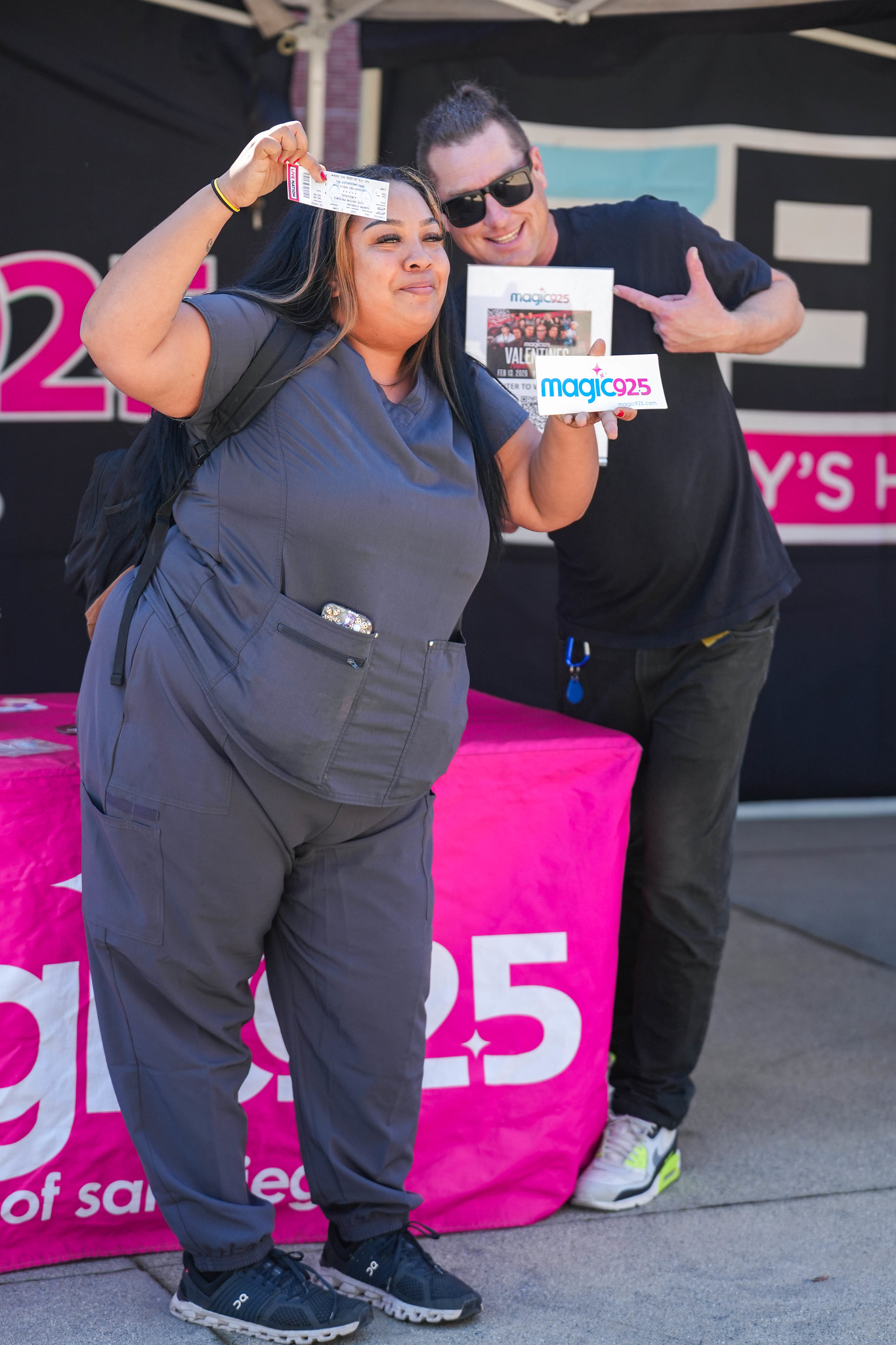 
A student holds up the prizes she won at a City College welcome tent.
