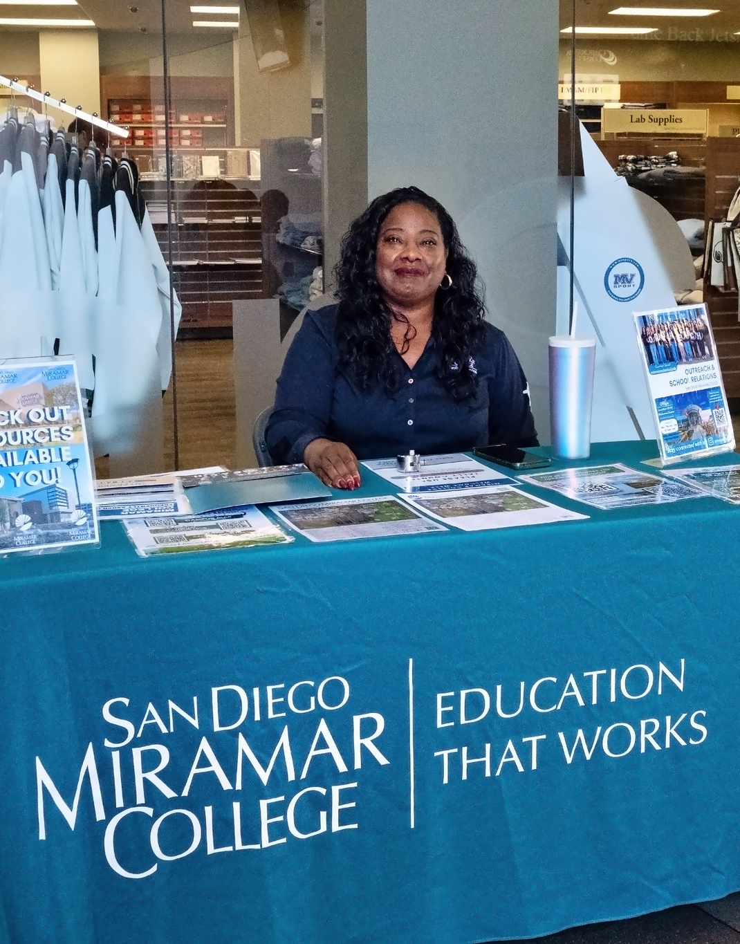 
An employee working a welcome table at Miramar.
