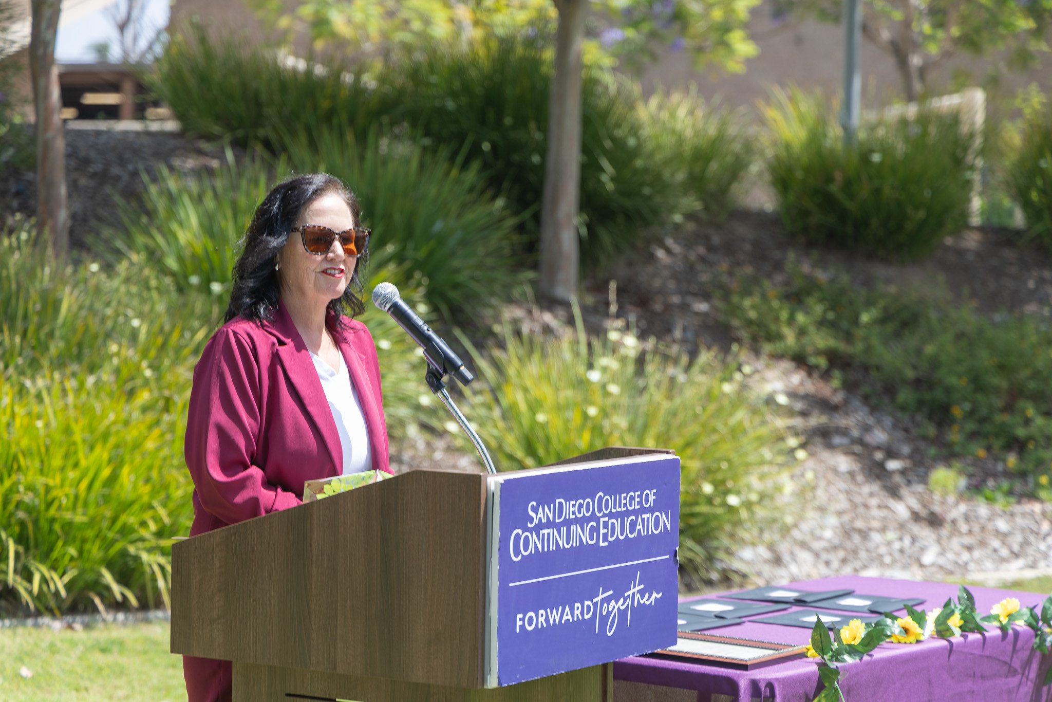 A speaker at a podium at College of Continuing Education's event.&nbsp;