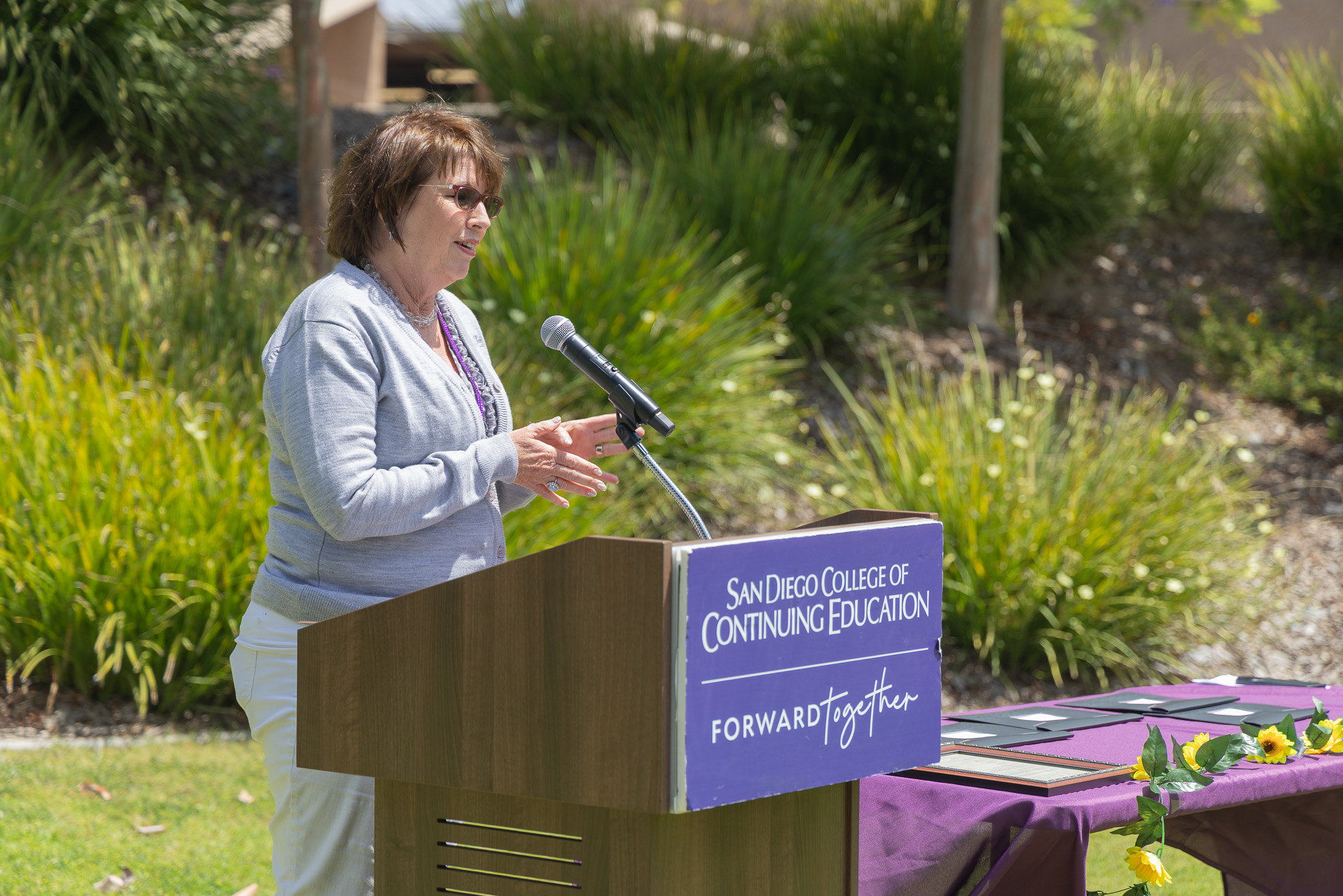A speaker at a podium at College of Continuing Education's event.&nbsp;