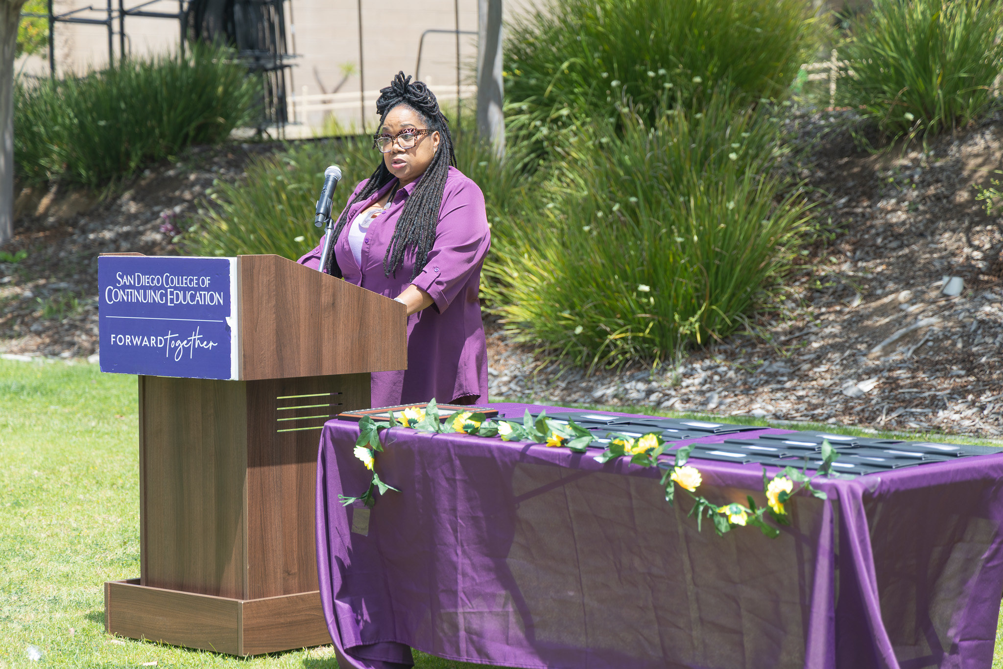 A speaker at a podium at College of Continuing Education's event.&nbsp;
