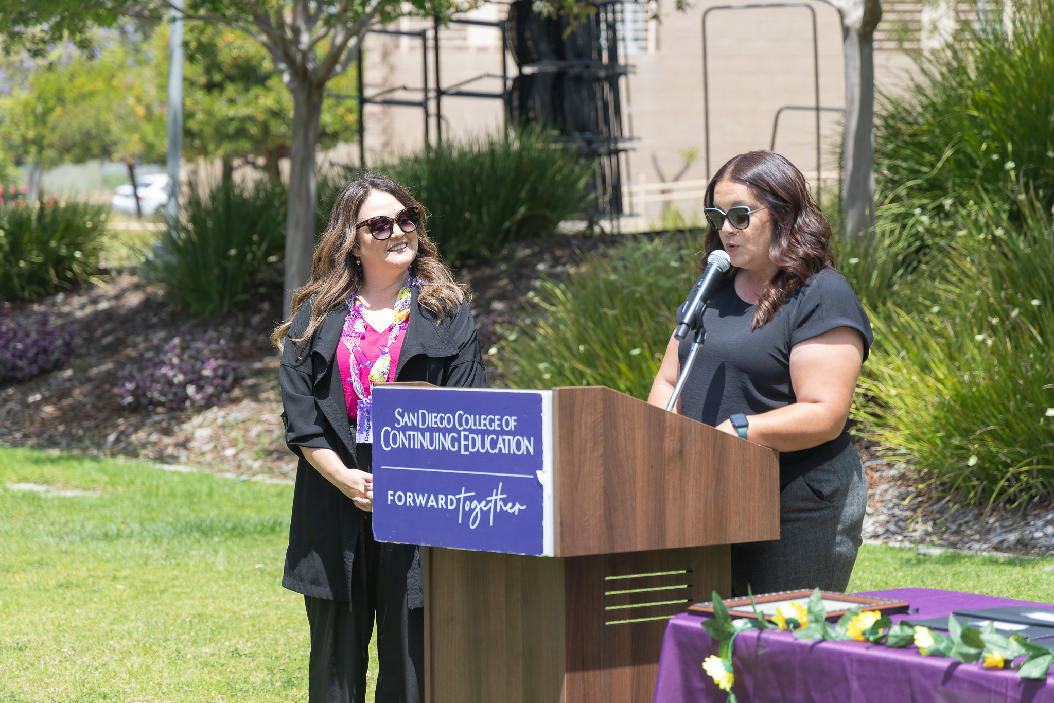 Two ladies at a podium at College of Continuing Education's event.