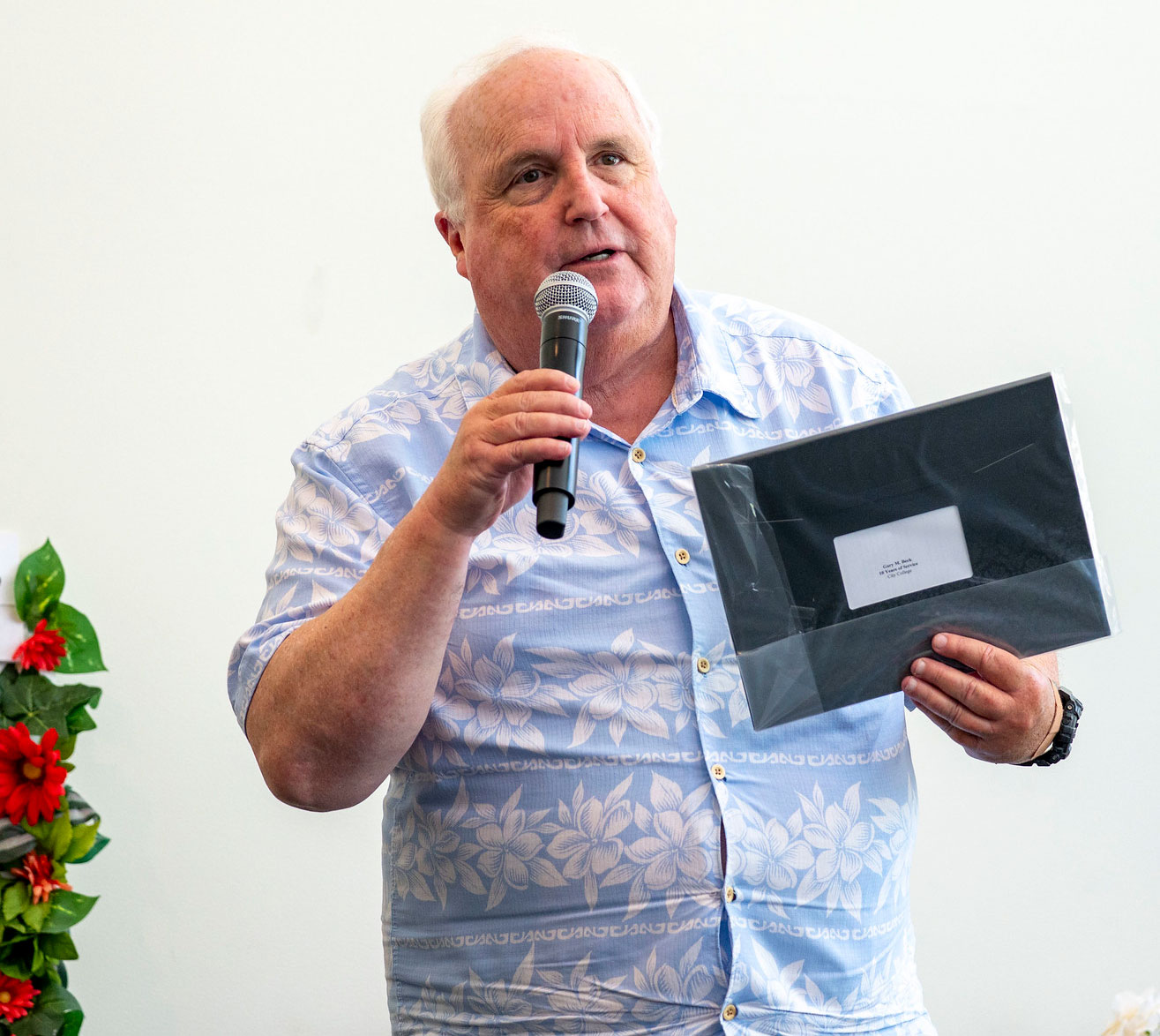 A City College employee receives his service certificate.