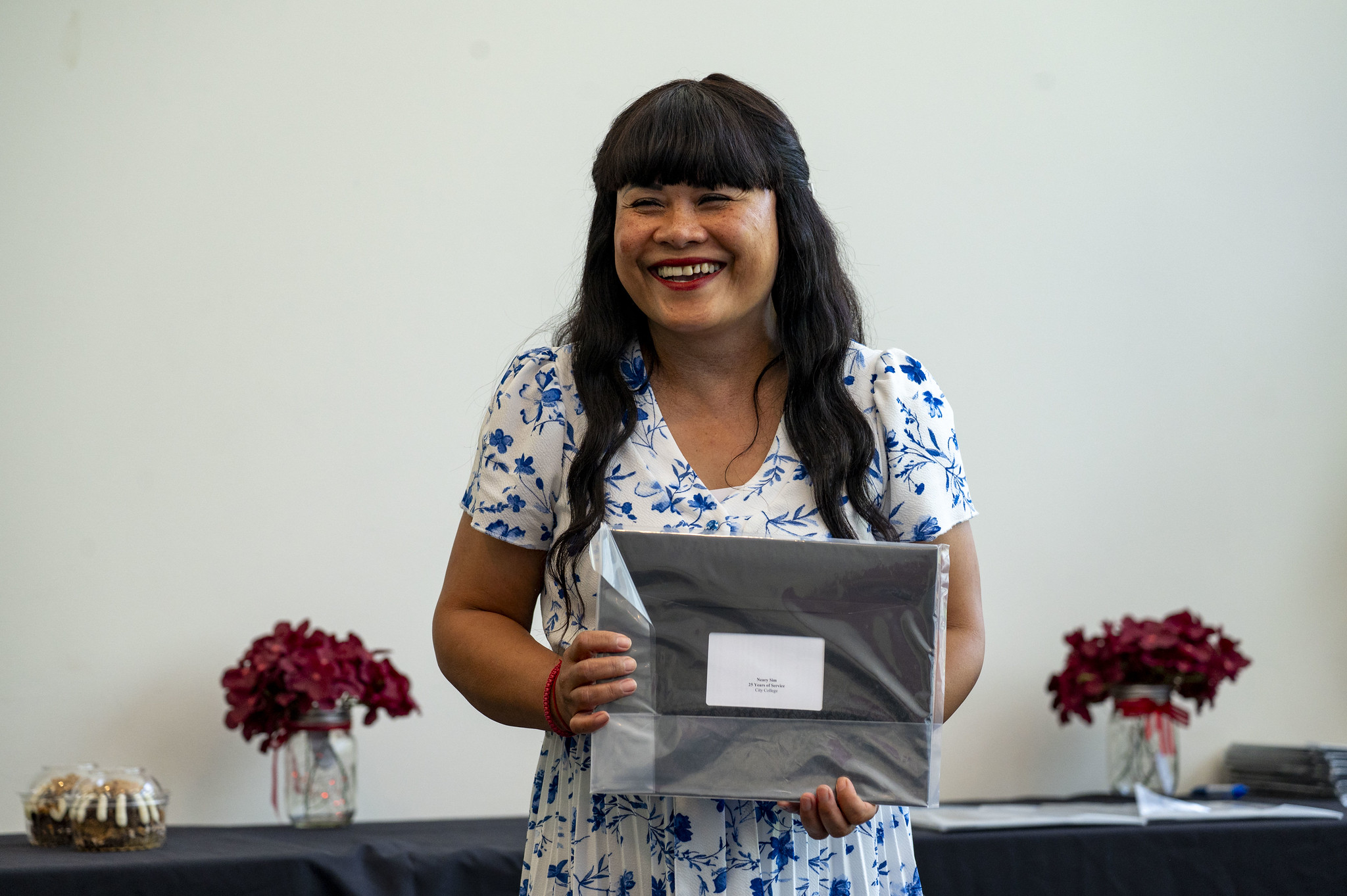 A City College employee receives her service certificate.