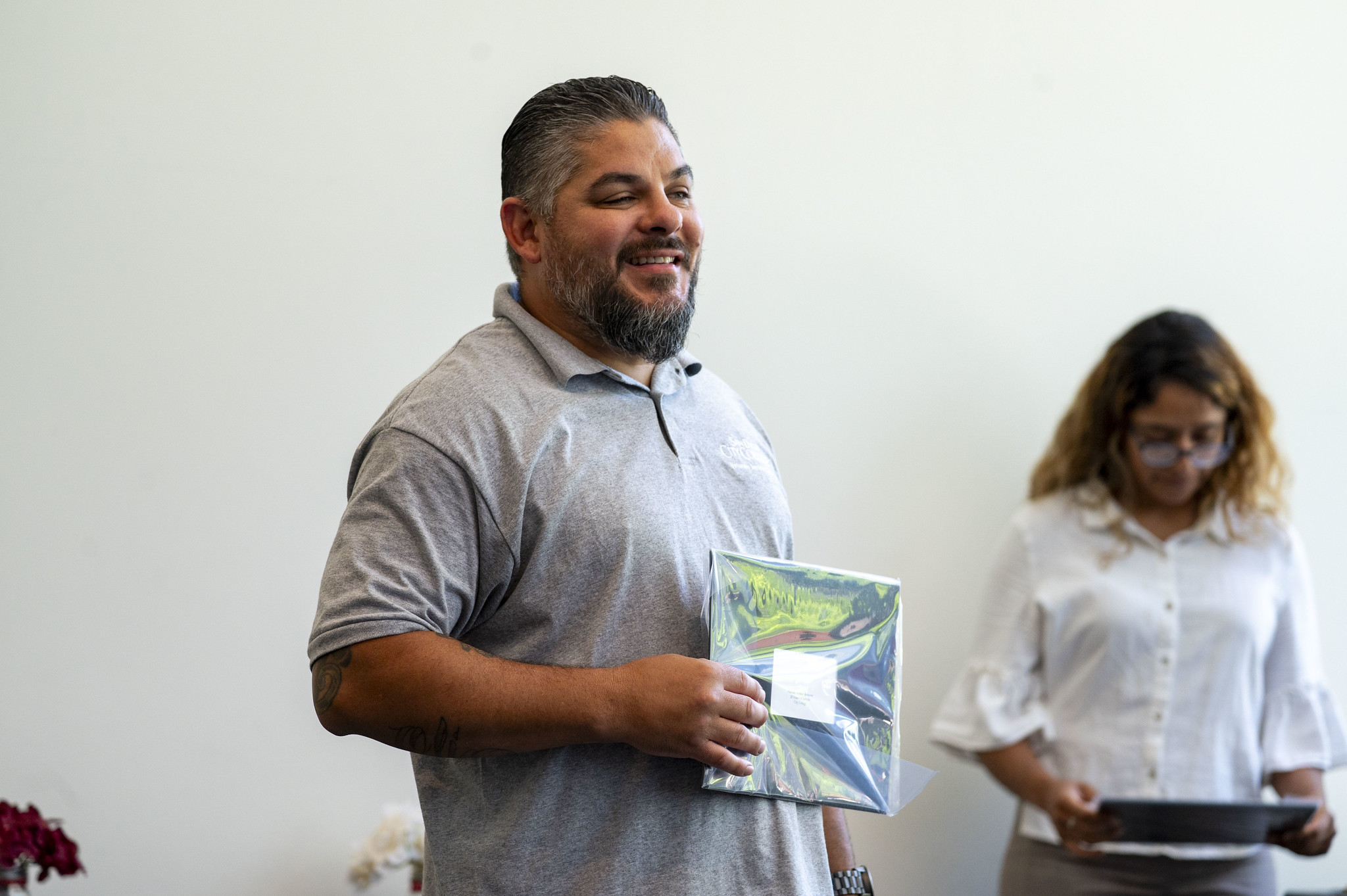 A City College employee receives his service certificate.