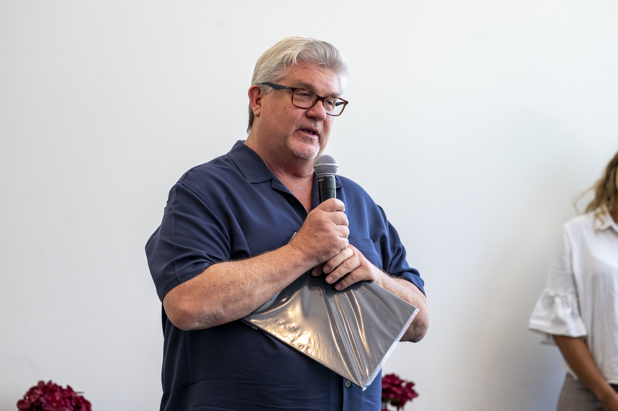 A City College employee receives his service certificate.