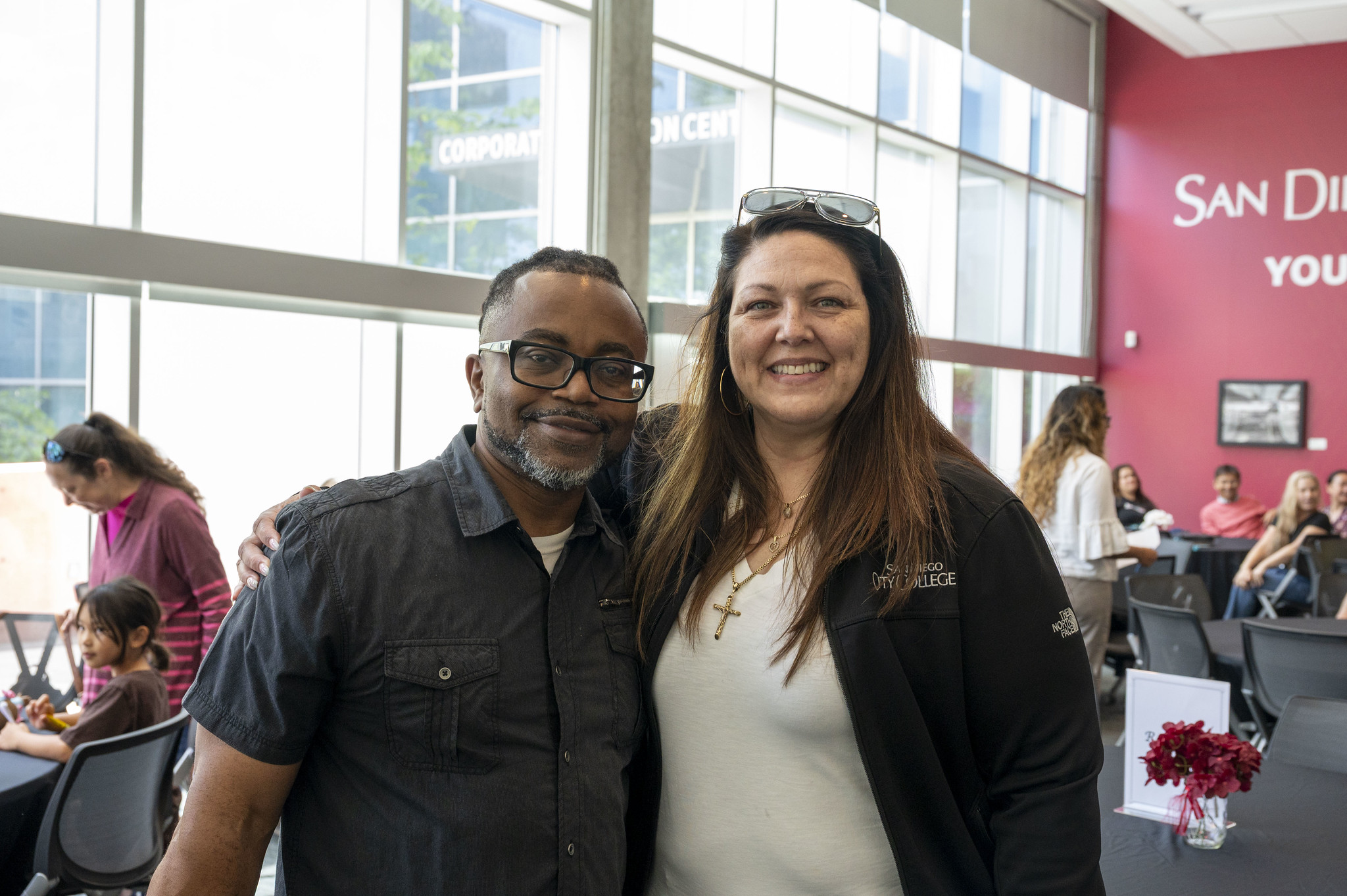Two employees at City College's event.&nbsp;