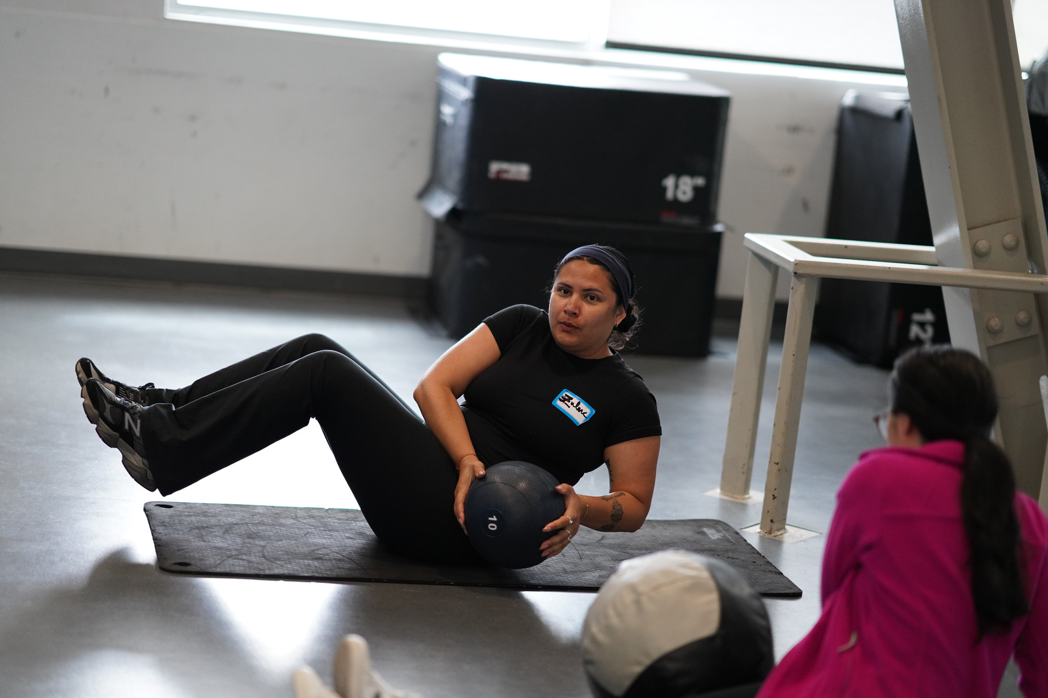 An employee checking out Mesa's gym works out with a medicine ball.