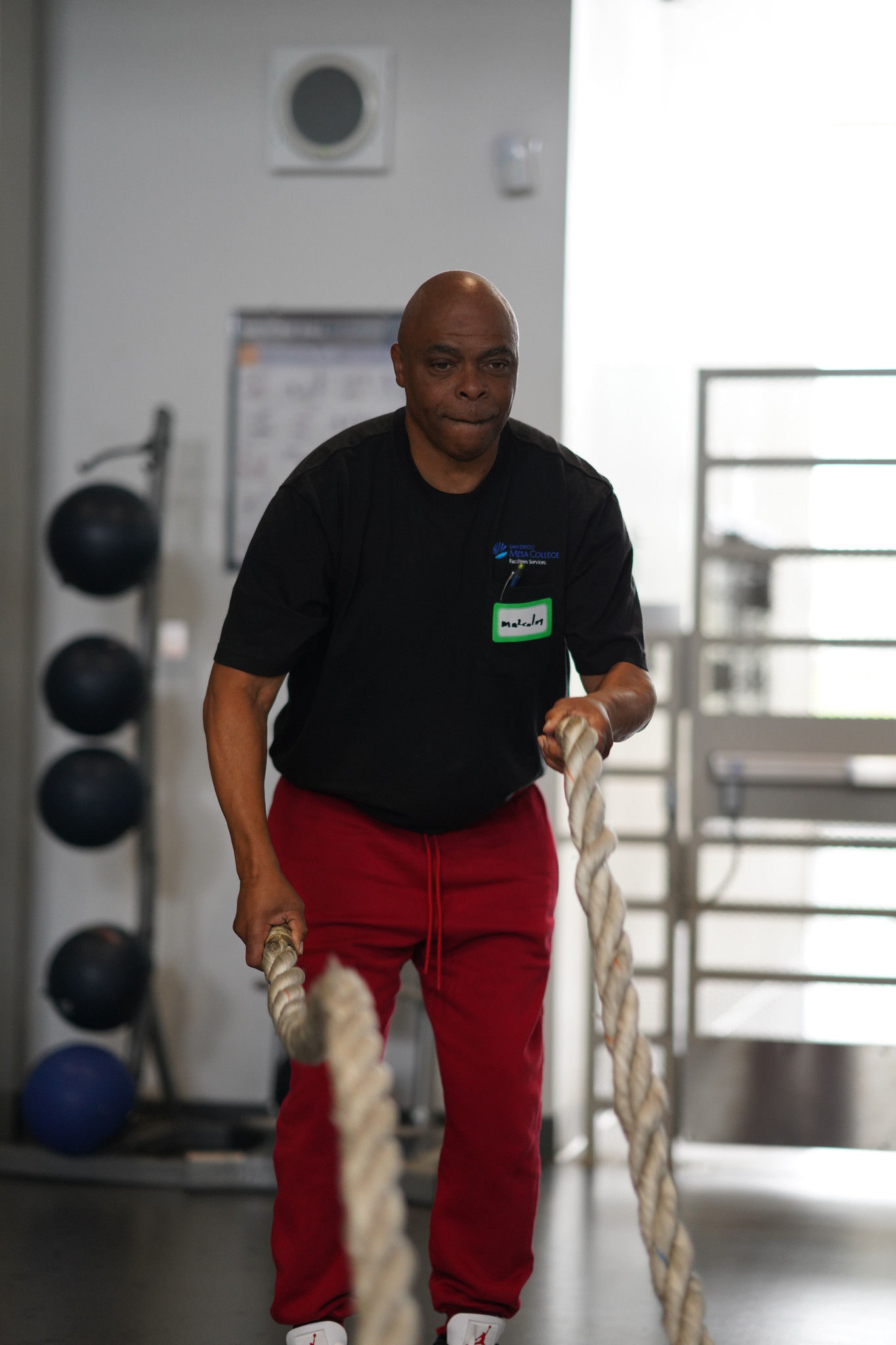 An employee checking out Mesa's gym works out with two ropes.&nbsp;