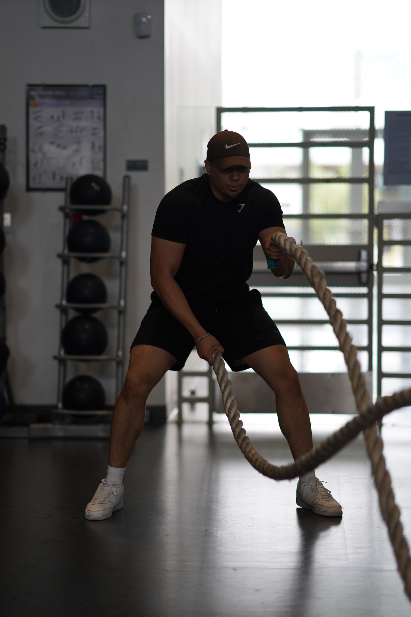An employee checking out Mesa's gym works out with two ropes.&nbsp;