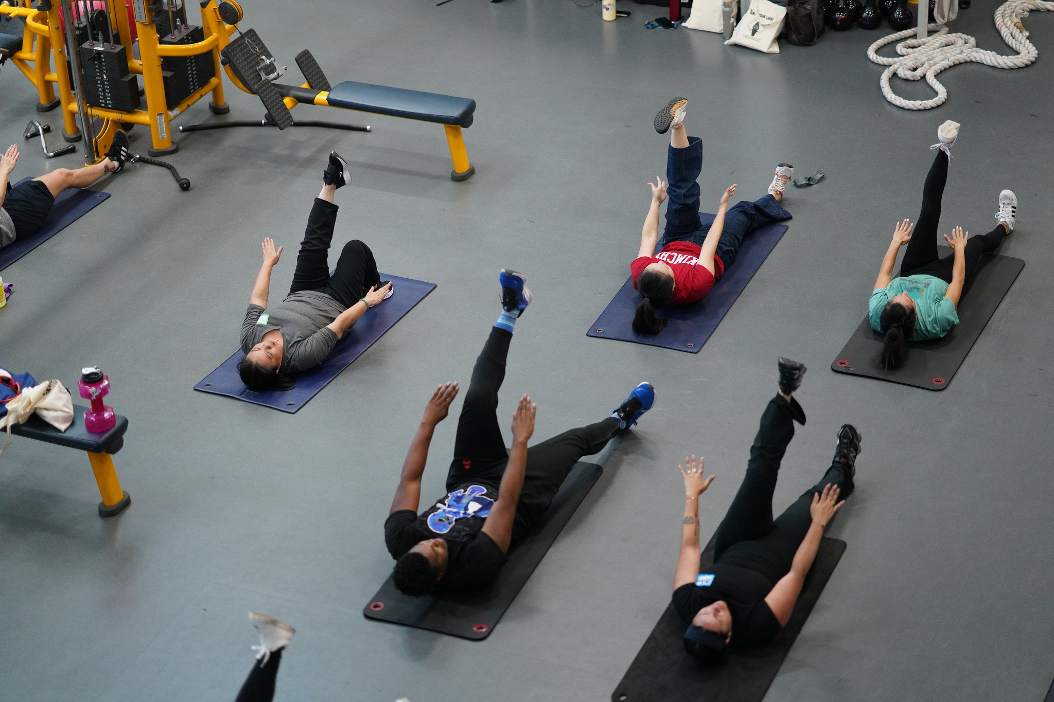 Six employees laying down on mats during an exercise at Mesa's gym.&nbsp;