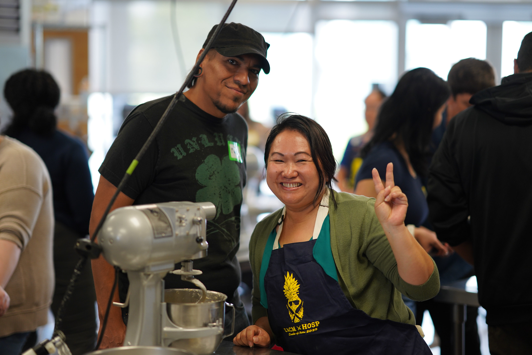 Two employees at a Mesa&nbsp; culinary station using a mixer.