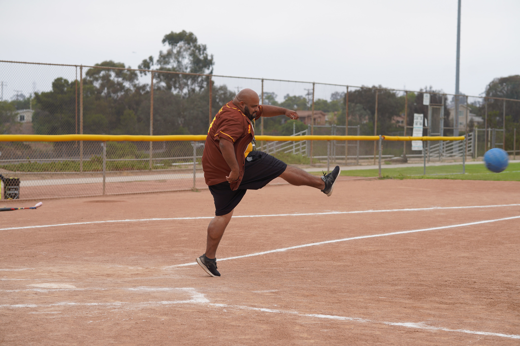 An employee winds up his leg to kick a ball.&nbsp;