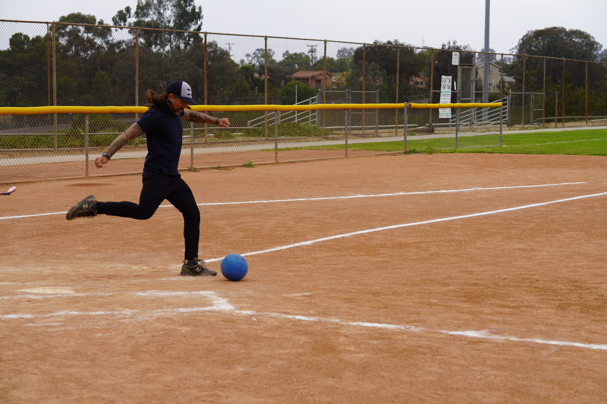 An employee winds up his leg to kick a ball.&nbsp;