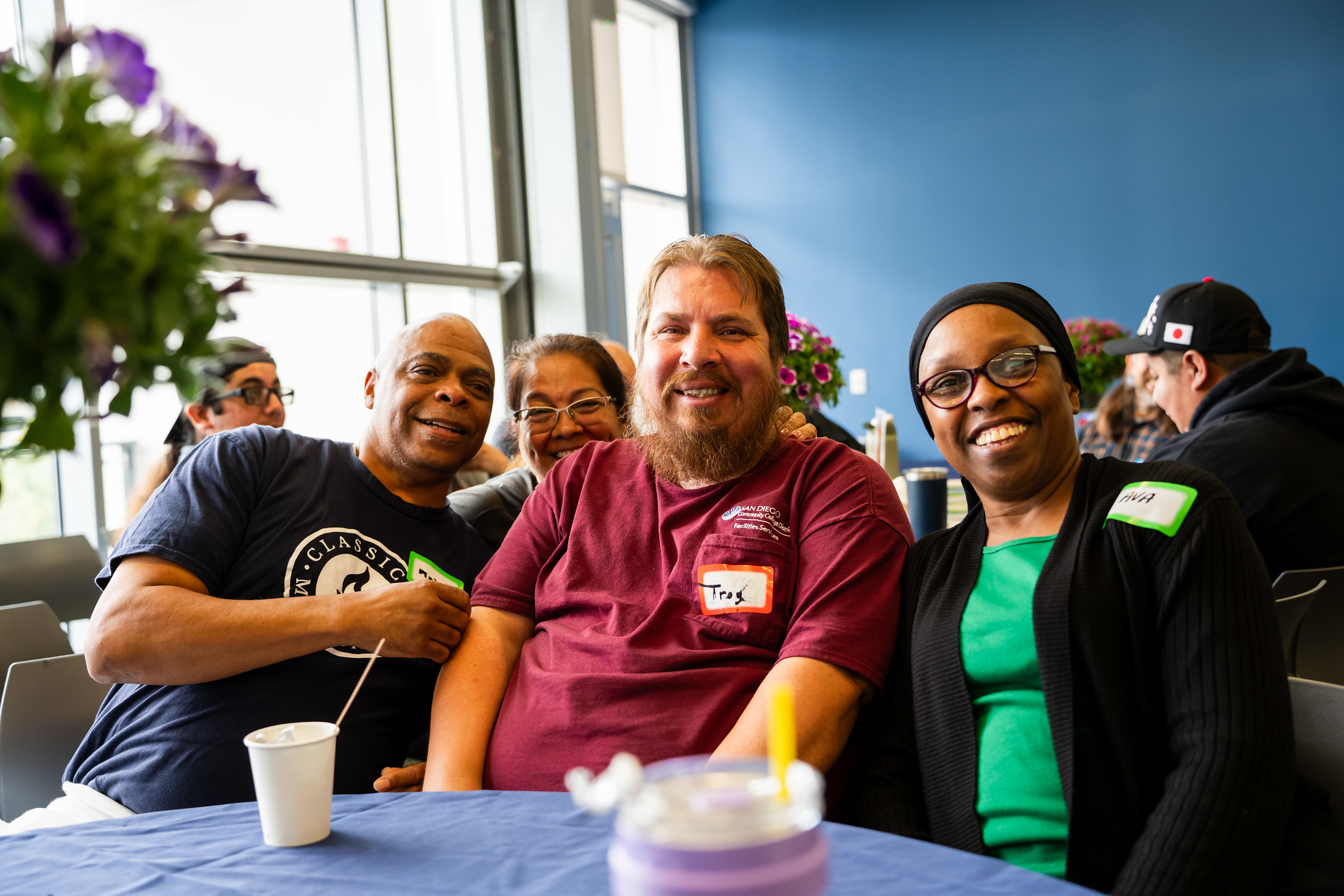 Three employees at a table at Mesa's event.&nbsp;