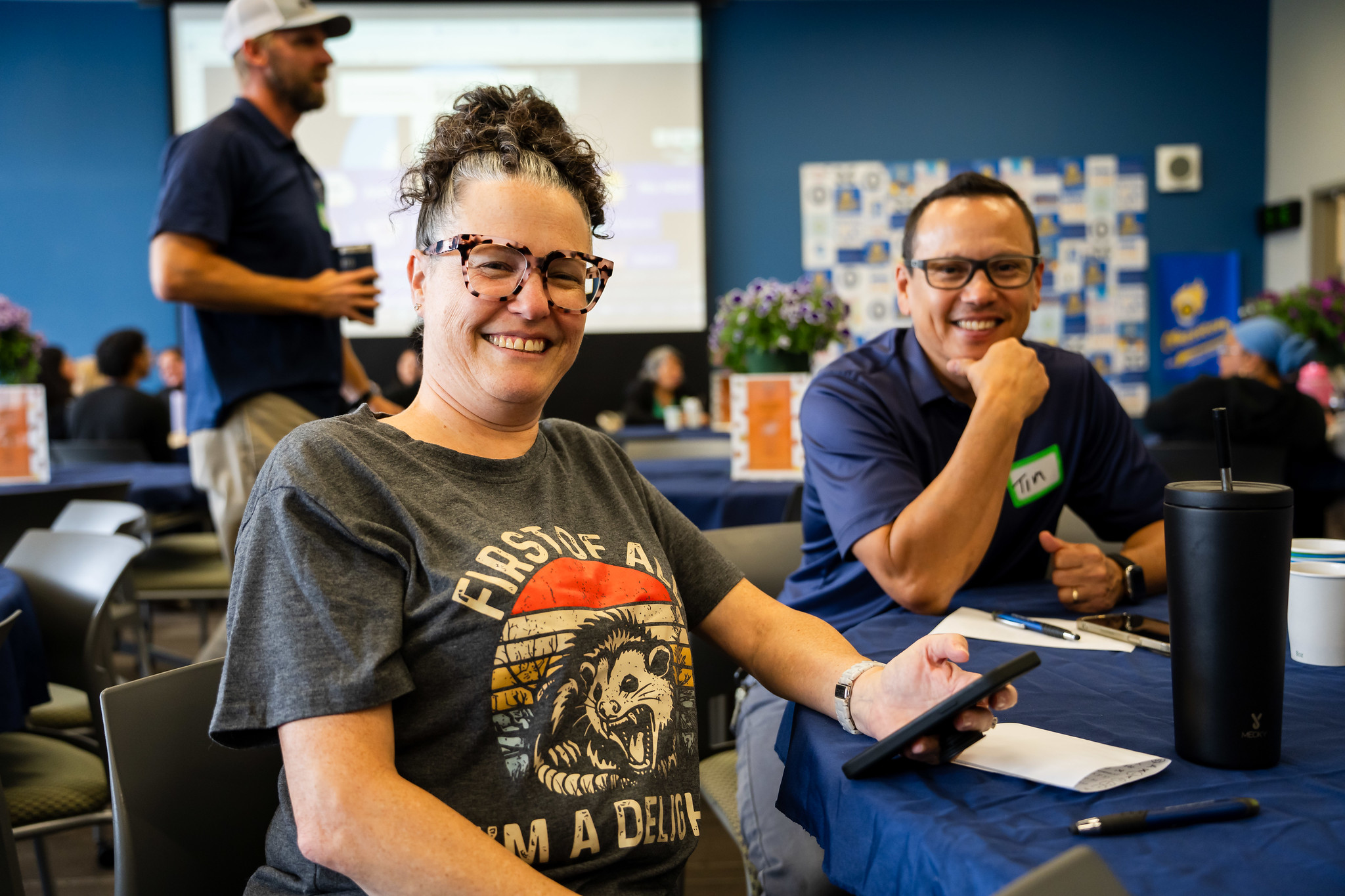 Two employees at a table at Mesa's event.&nbsp;