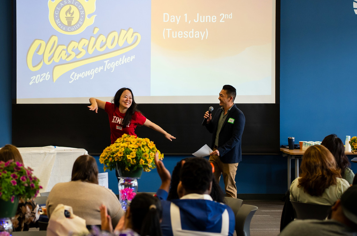 Two presenters in front of the audience at Mesa.