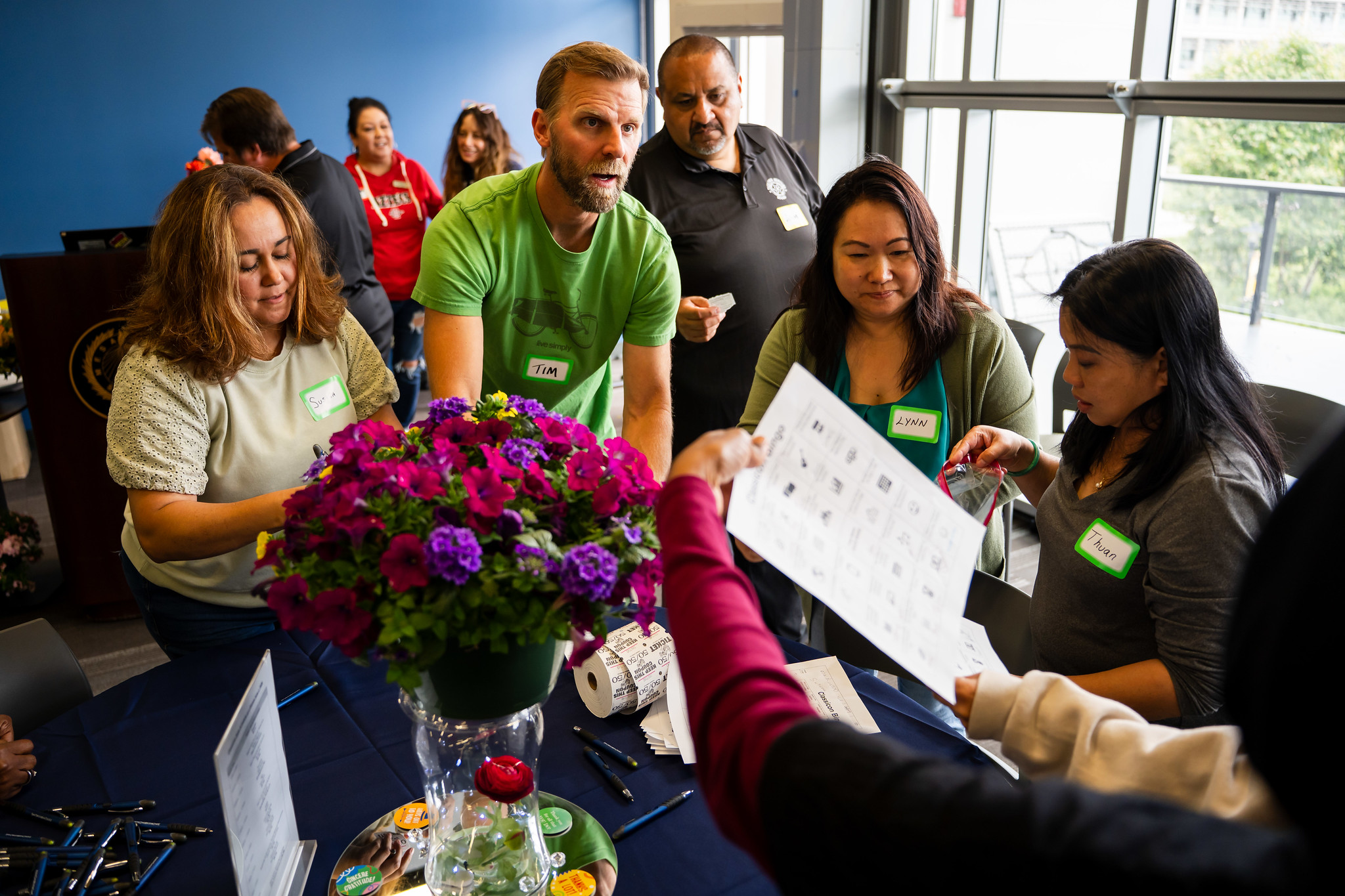 Five employees around a table playing a game at Mesa College's event.&nbsp;