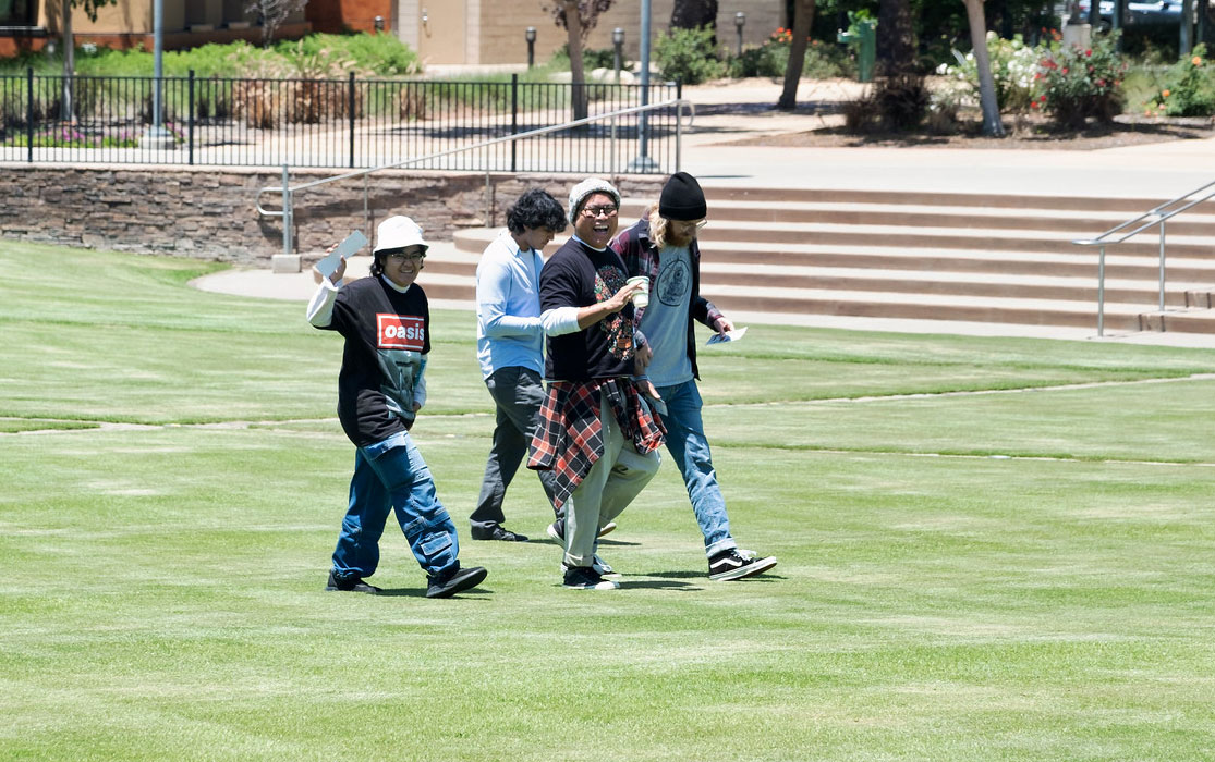 Four employees walking on the grass at Miramar.&nbsp;