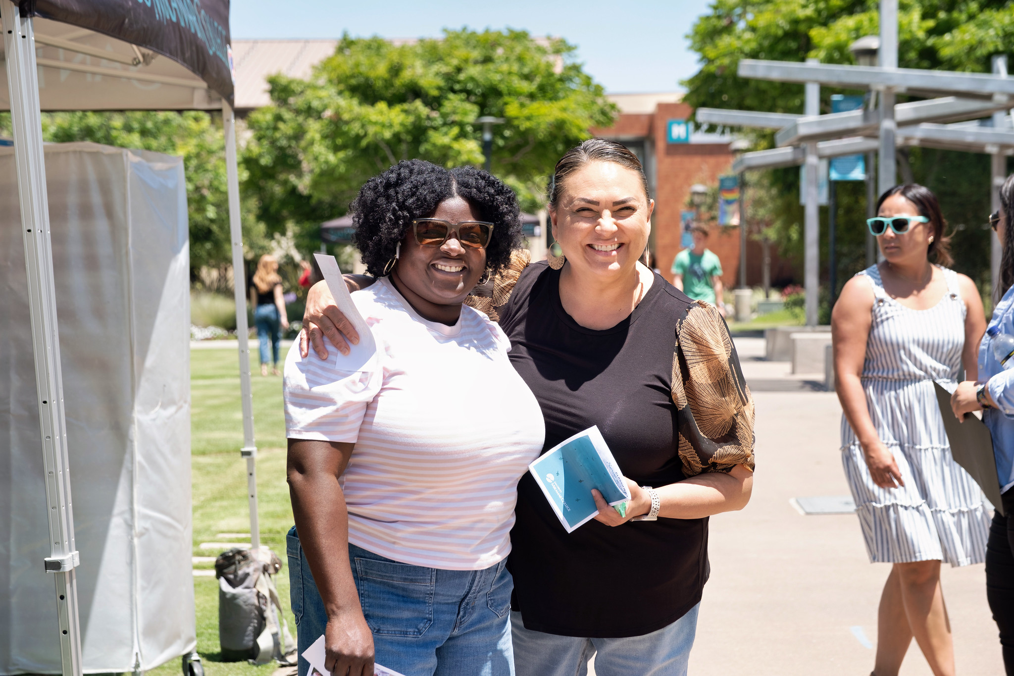 Two employees near a tent at Miramar's event.&nbsp;