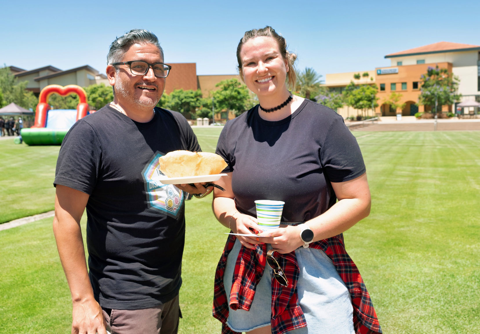 Two employees with their lunch on the grass at Miramar.&nbsp;