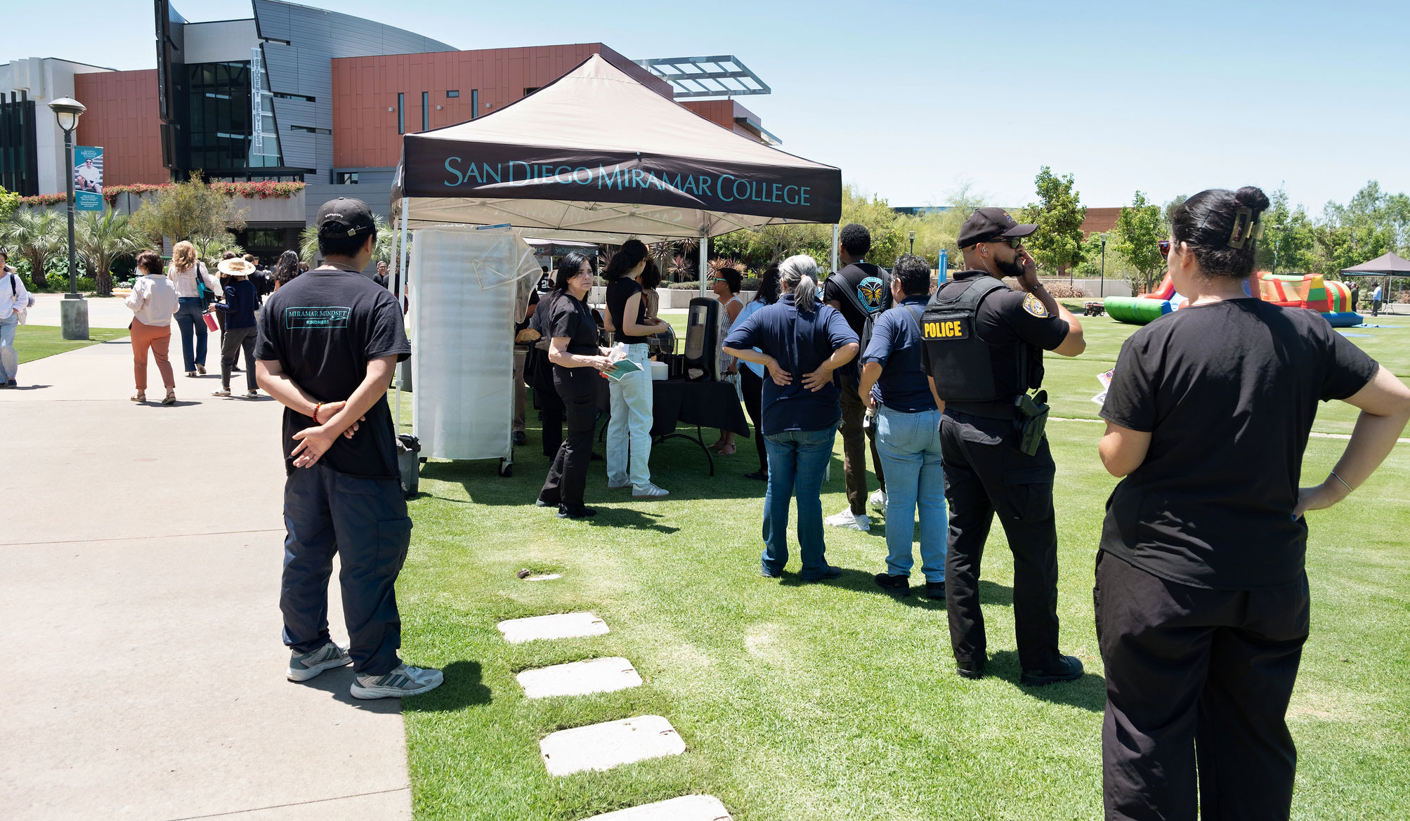 Miramar employees line up near a tent to get their lunch.